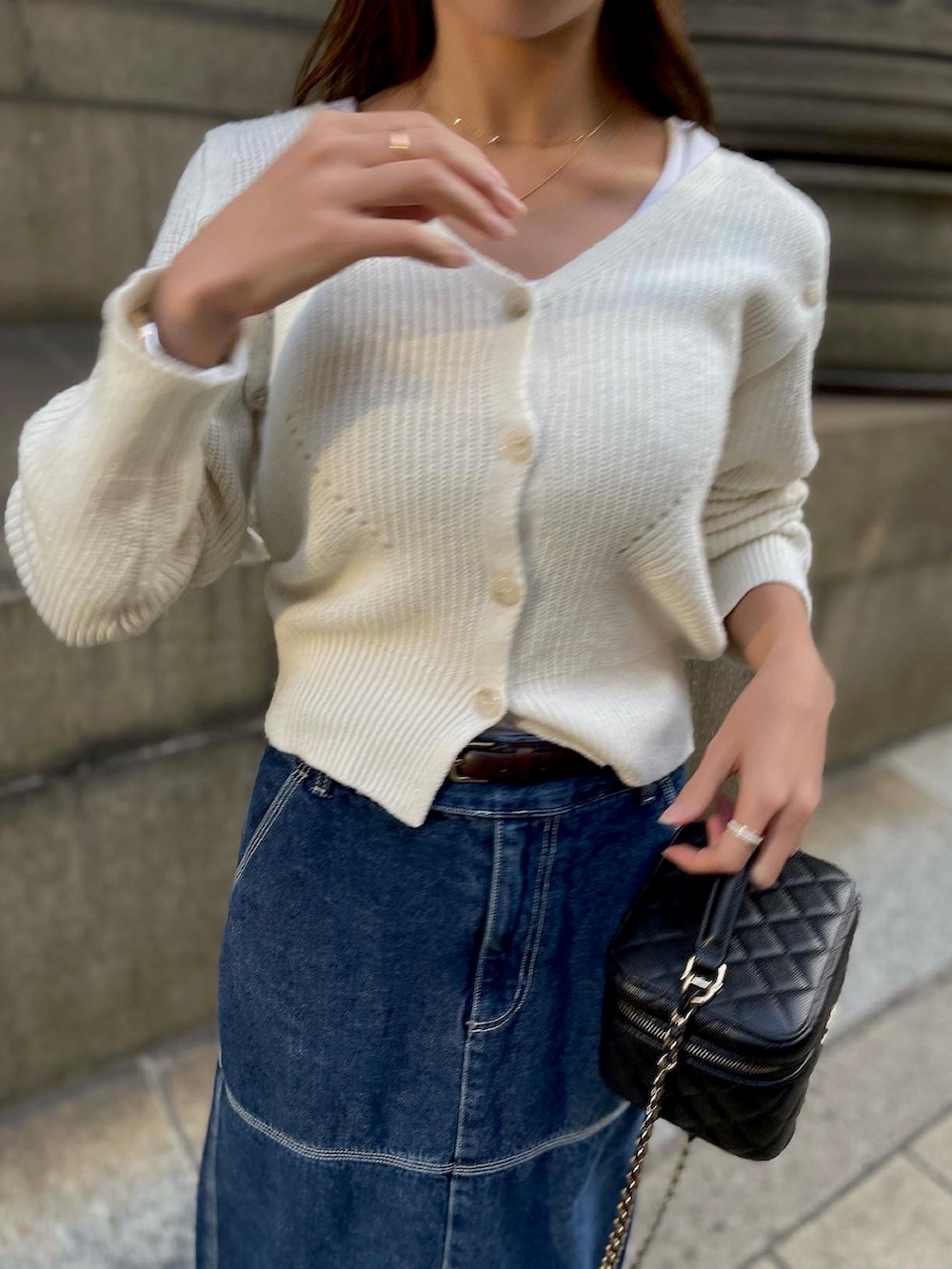 ブルー系のデニムスカート、ホワイト系のニット/セーターを着用したレディースの秋コーディネートの3枚目の写真