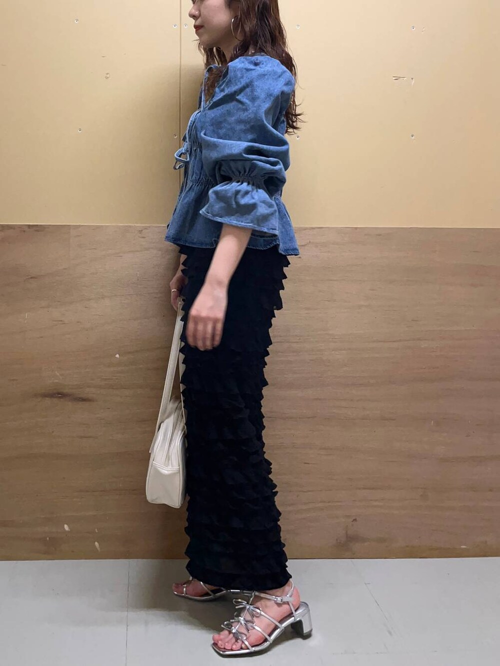 ホワイト系のハンドバッグ、ブルー系のシャツ/ブラウス、ブラック系のスカートを着用したレディースの春コーディネートの2枚目の写真