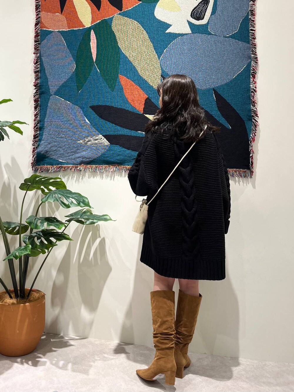 ブラウン系のブーツ、ホワイト系のショルダーバッグを着用したレディースの秋コーディネートの5枚目の写真