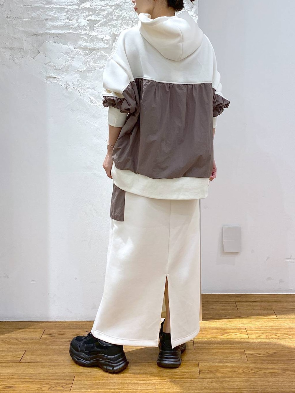 ホワイト系のショルダーバッグ、ブラック系のスニーカー、ホワイト系のパーカーを着用したレディースの秋コーディネートの3枚目の写真