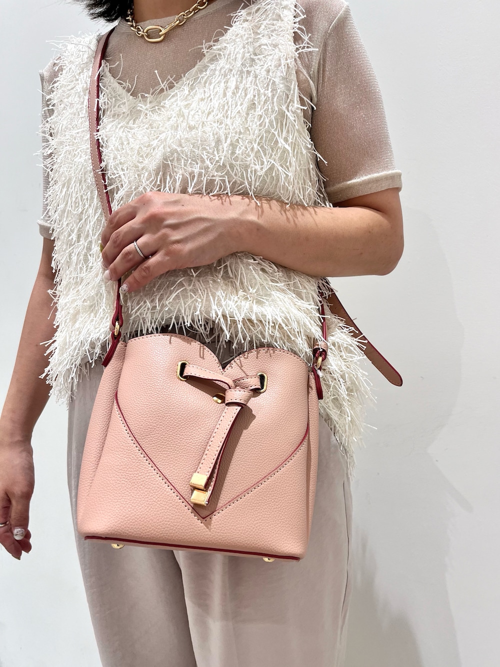 ホワイト系のタンクトップ、ホワイト系のTシャツ/カットソー、ホワイト系のスラックスを着用したレディースの夏コーディネートの5枚目の写真