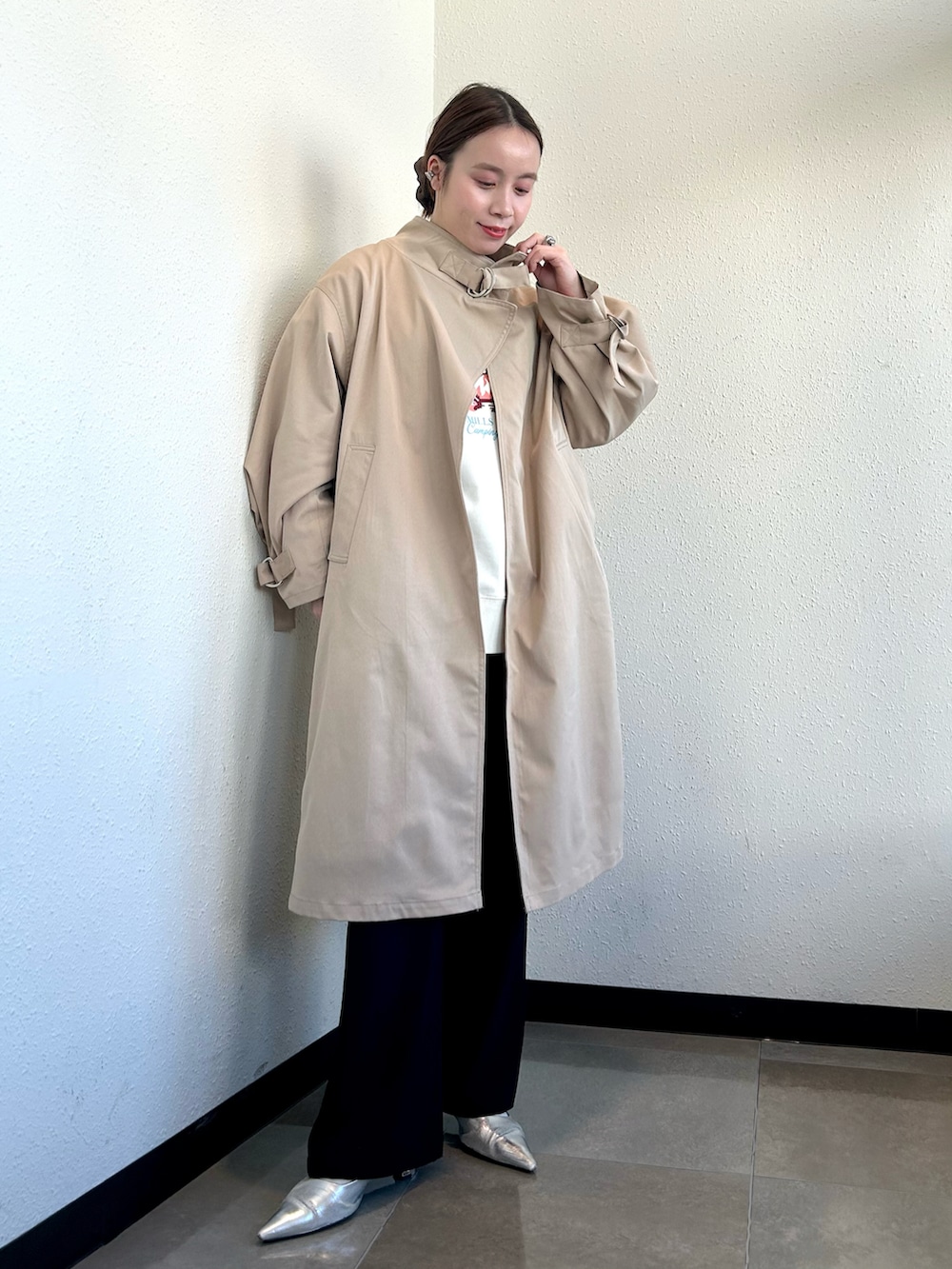 ホワイト系のスウェット、ベージュ系のトレンチコート、ブラック系のその他パンツを着用したレディースの冬コーディネートの4枚目の写真