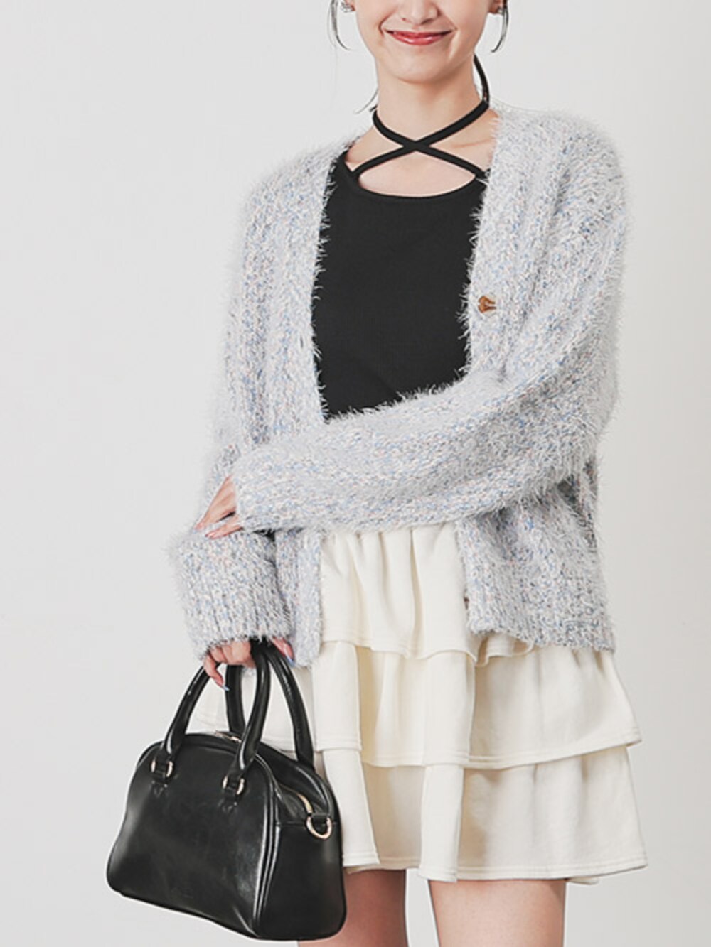 ブラック系のTシャツ/カットソー、ブラック系のボストンバッグ、ホワイト系のスカートを着用したレディースの秋コーディネートの2枚目の写真