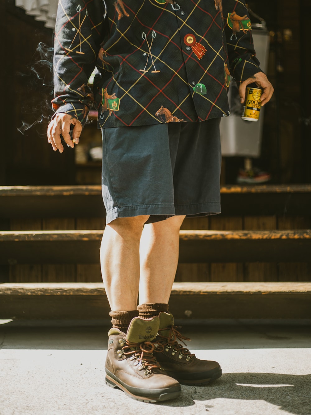 ブラック系のシャツ/ブラウス、ブルー系のチノパンツ、ブラウン系のブーツを着用したメンズの秋コーディネートの2枚目の写真