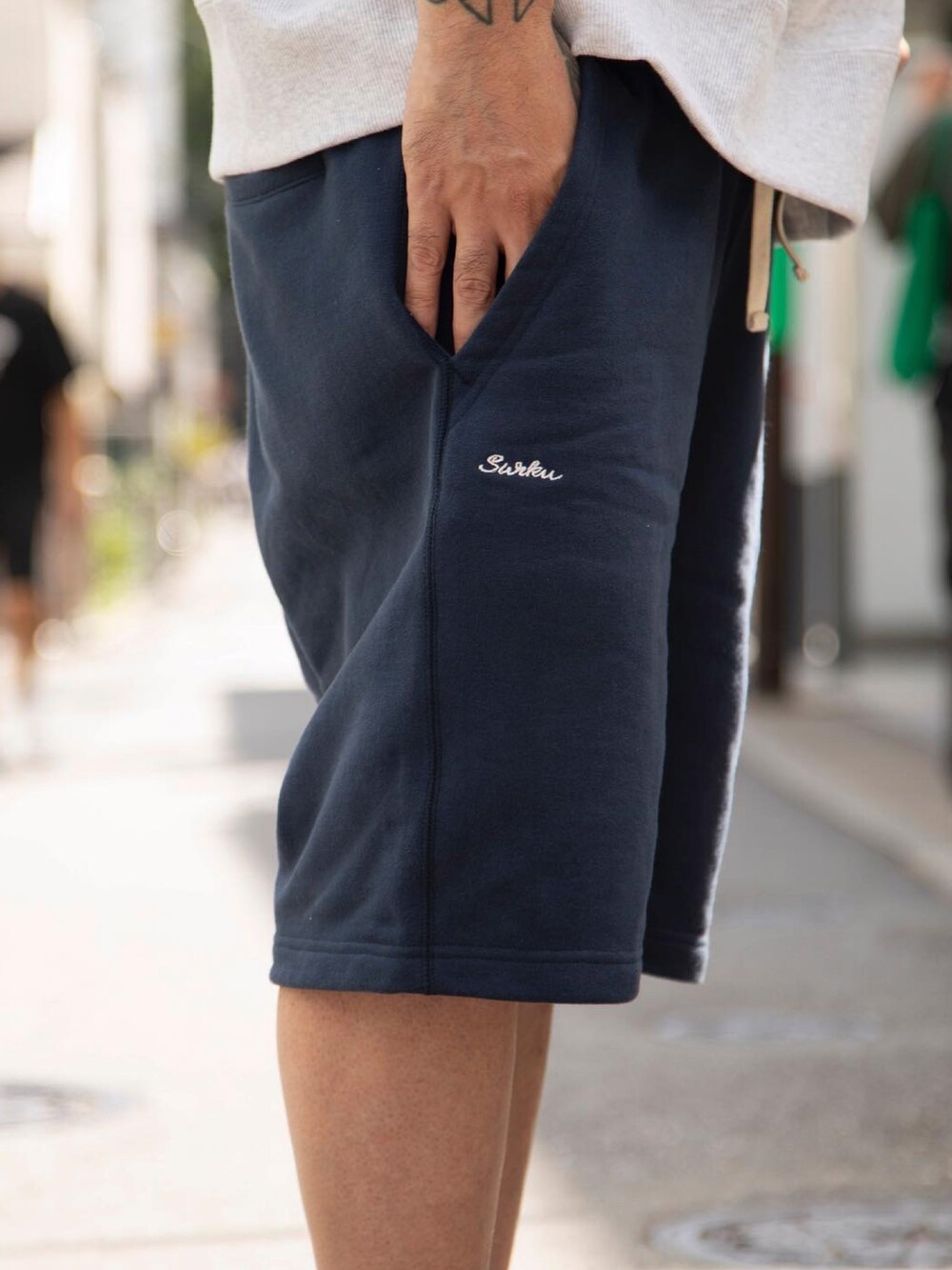 グレー系のTシャツ/カットソー、ブルー系のスウェットパンツ、グレー系のスニーカーを着用したメンズの夏コーディネートの2枚目の写真