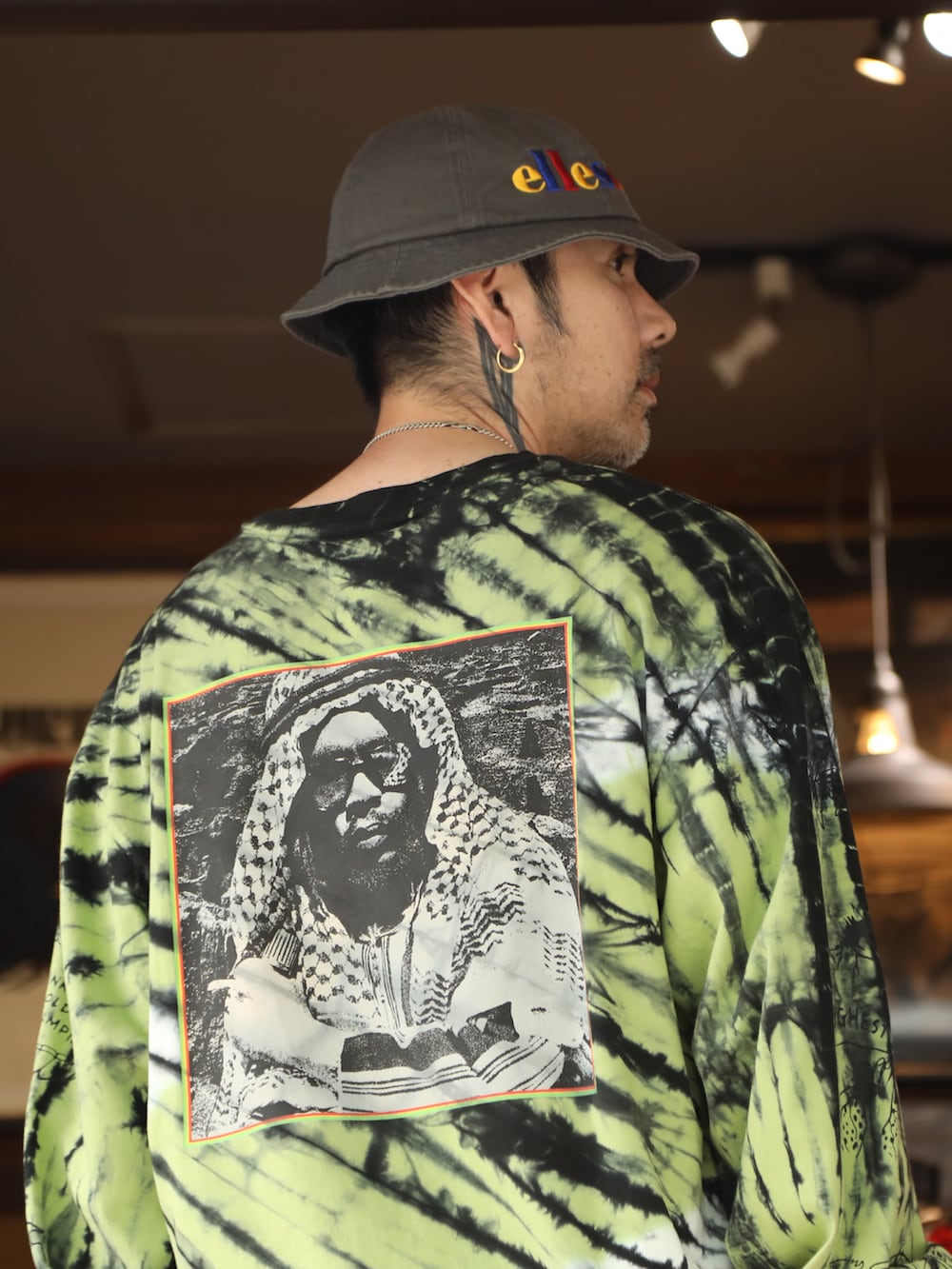 イエロー系のTシャツ/カットソー、レッド系のその他パンツ、グレー系のハットを着用したメンズの夏コーディネートの3枚目の写真