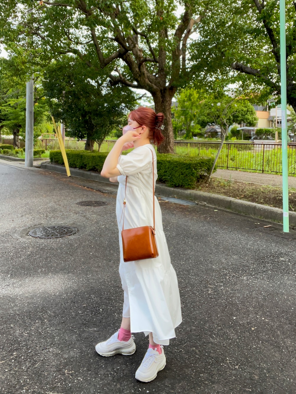 ホワイト系のワンピース/ドレス、ブラウン系のバッグ、ホワイト系のスニーカーを着用したレディースの夏コーディネートの3枚目の写真