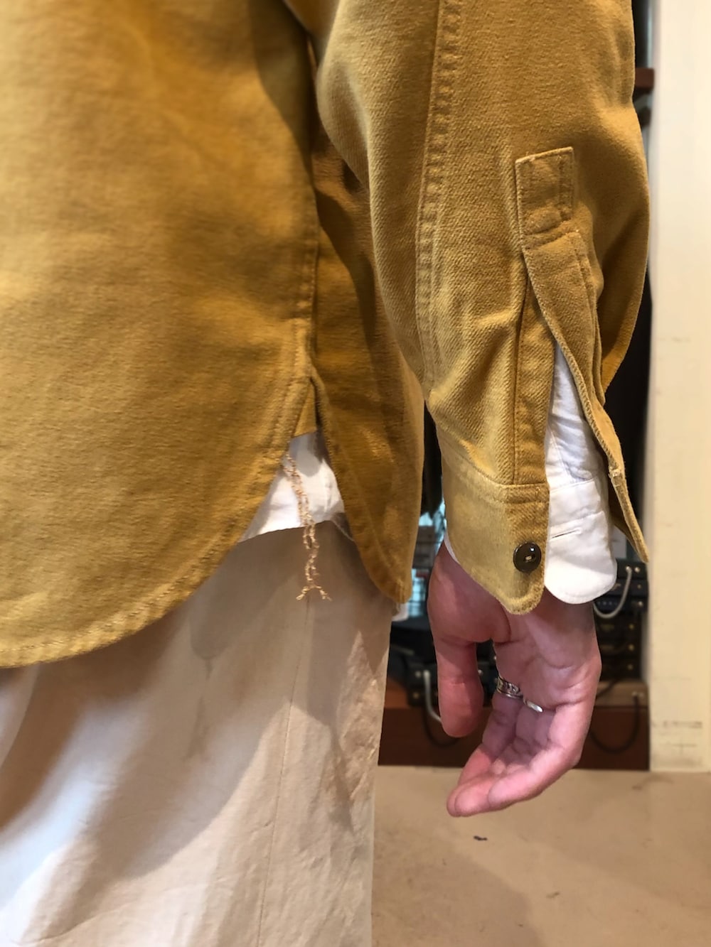 ベージュ系のチノパンツ、ブラウン系のローファー、イエロー系のシャツ/ブラウスを着用したメンズの秋コーディネートの4枚目の写真