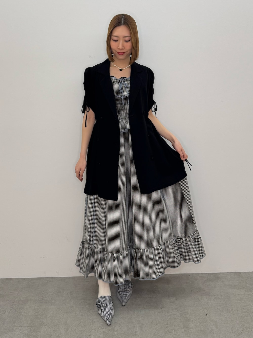 ブラック系のワンピース、ブラック系のワンピース、ブラック系のパンプスを着用したレディースの春コーディネートの2枚目の写真