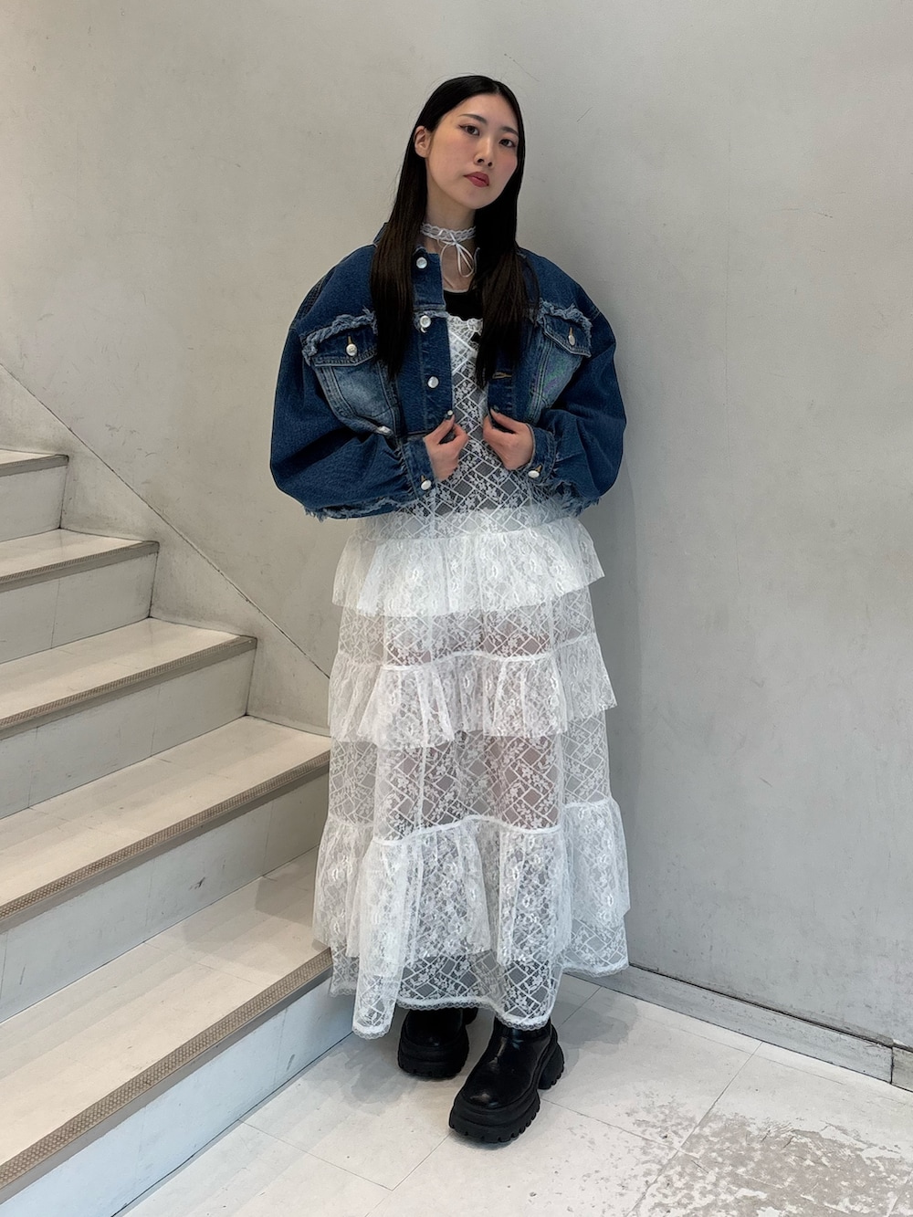 ホワイト系のワンピース、ブルー系のデニムジャケット、ブラック系のTシャツ/カットソーを着用したレディースの春コーディネートの3枚目の写真