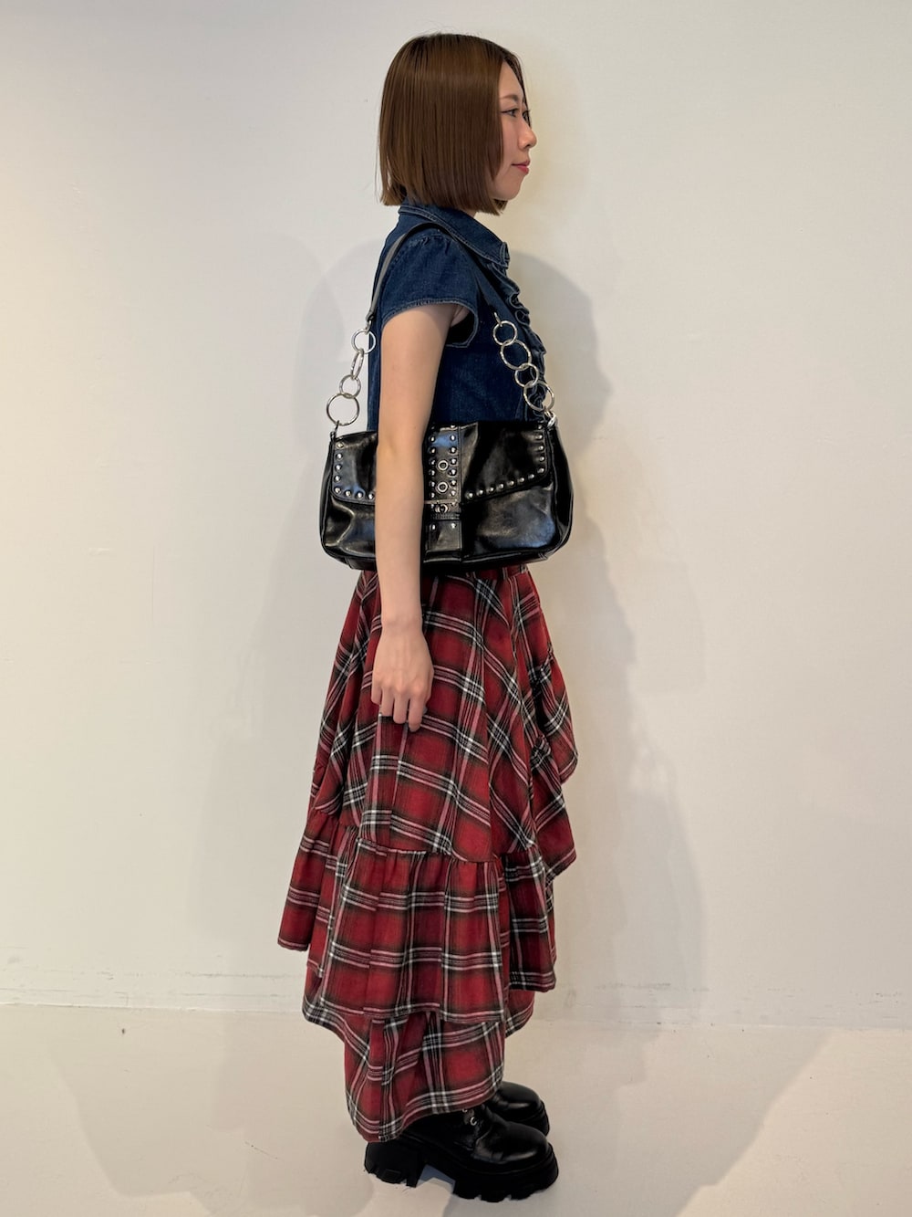 ブルー系のシャツ/ブラウス、レッド系のスカート、ブラック系のハンドバッグを着用したレディースの春コーディネートの3枚目の写真