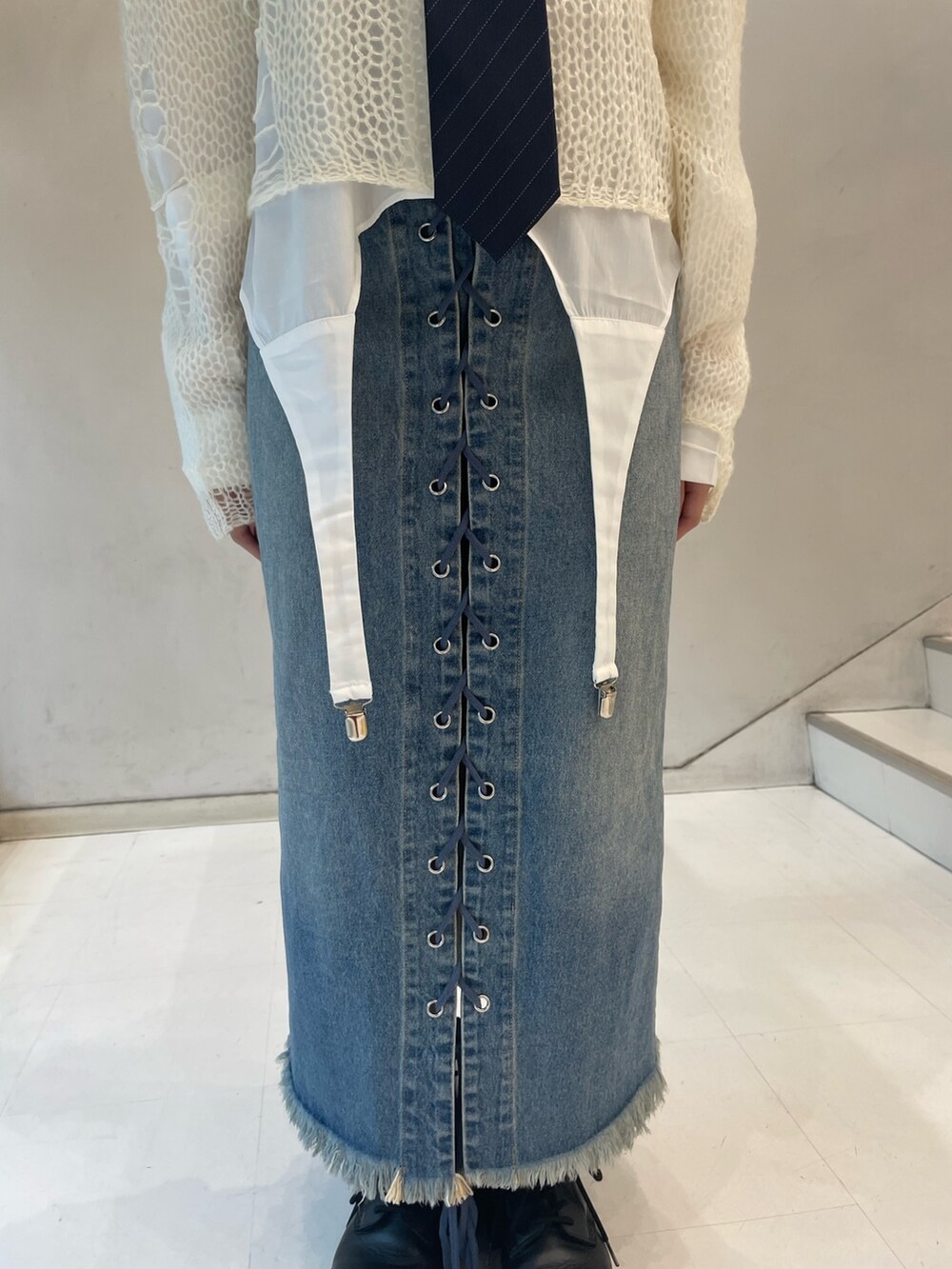 ホワイト系のニット/セーター、ホワイト系のシャツ/ブラウス、ブルー系のデニムパンツを着用したレディースの秋コーディネートの8枚目の写真