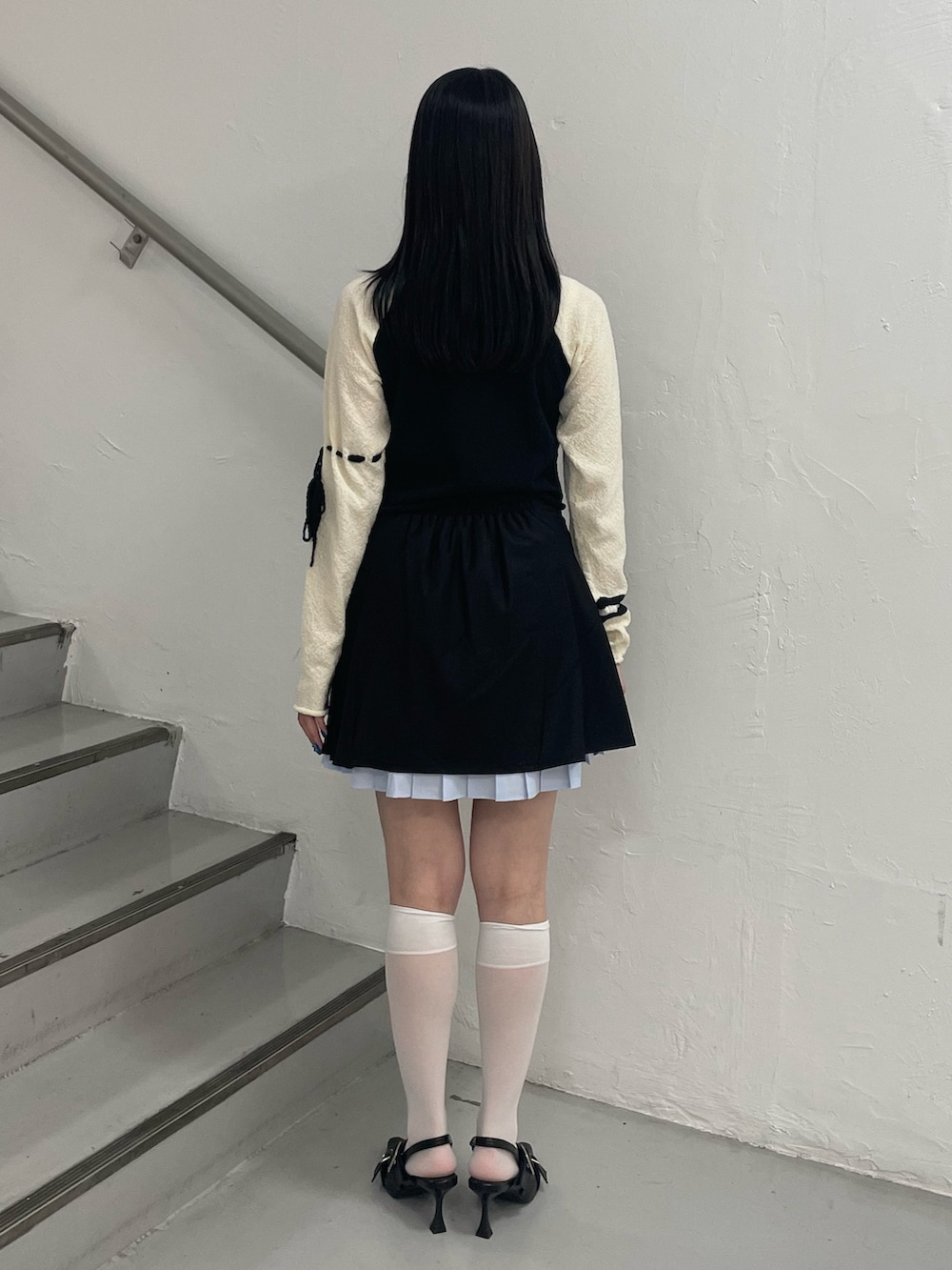 ブラック系のスカート、ブラック系のパンプス、ブラック系のニット/セーターを着用したレディースの夏コーディネートの4枚目の写真