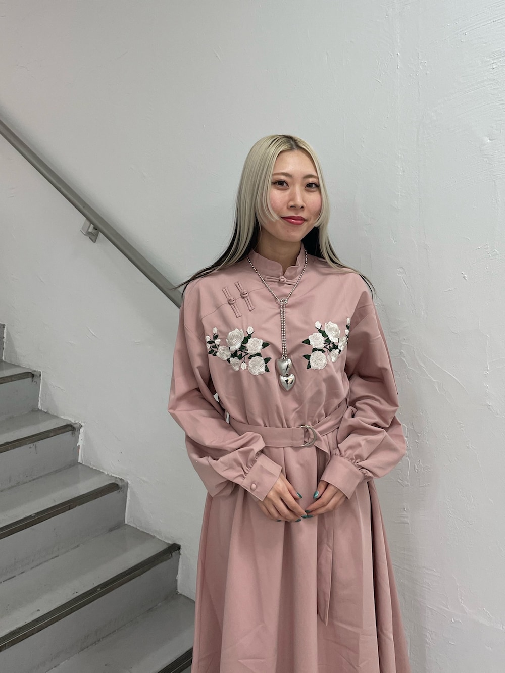 ピンク系のワンピース、シルバー系のネックレスを着用したレディースの冬コーディネートの5枚目の写真