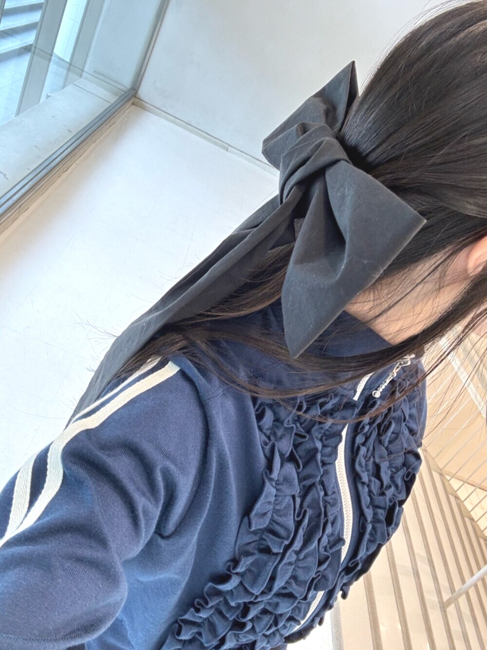 ブラック系のその他パンツ、ブルー系のジャージ、ブラック系のバレッタ/ヘアクリップを着用したレディースの冬コーディネートの10枚目の写真