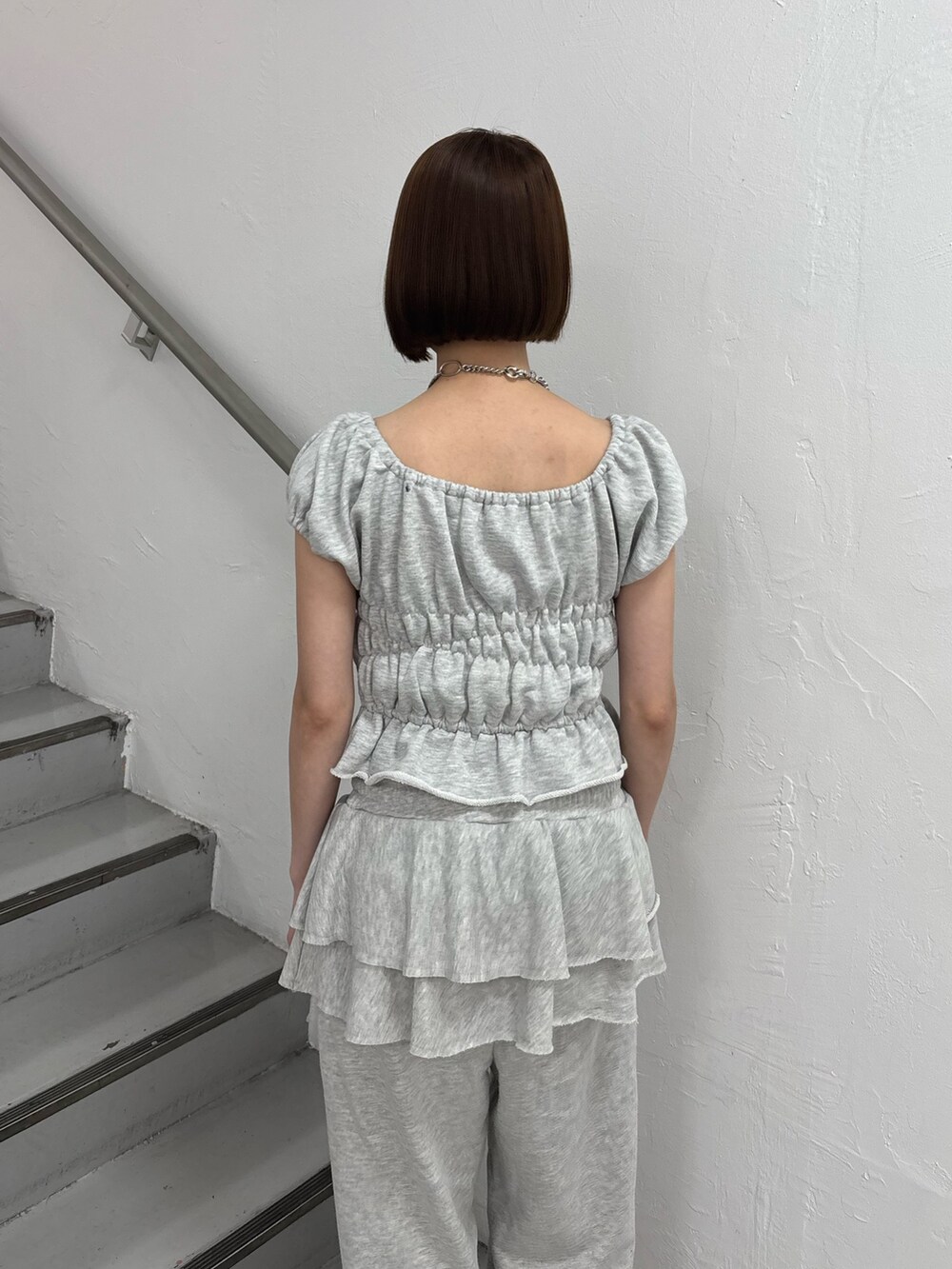 グレー系のスウェットパンツ、グレー系のTシャツ/カットソー、ピンク系のパンプスを着用したレディースの夏コーディネートの8枚目の写真