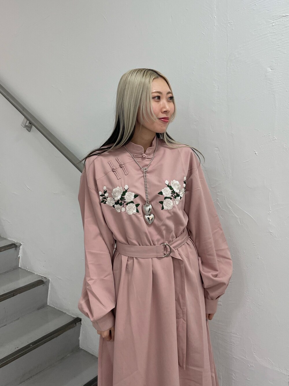 ピンク系のワンピース、シルバー系のネックレスを着用したレディースの冬コーディネートの6枚目の写真