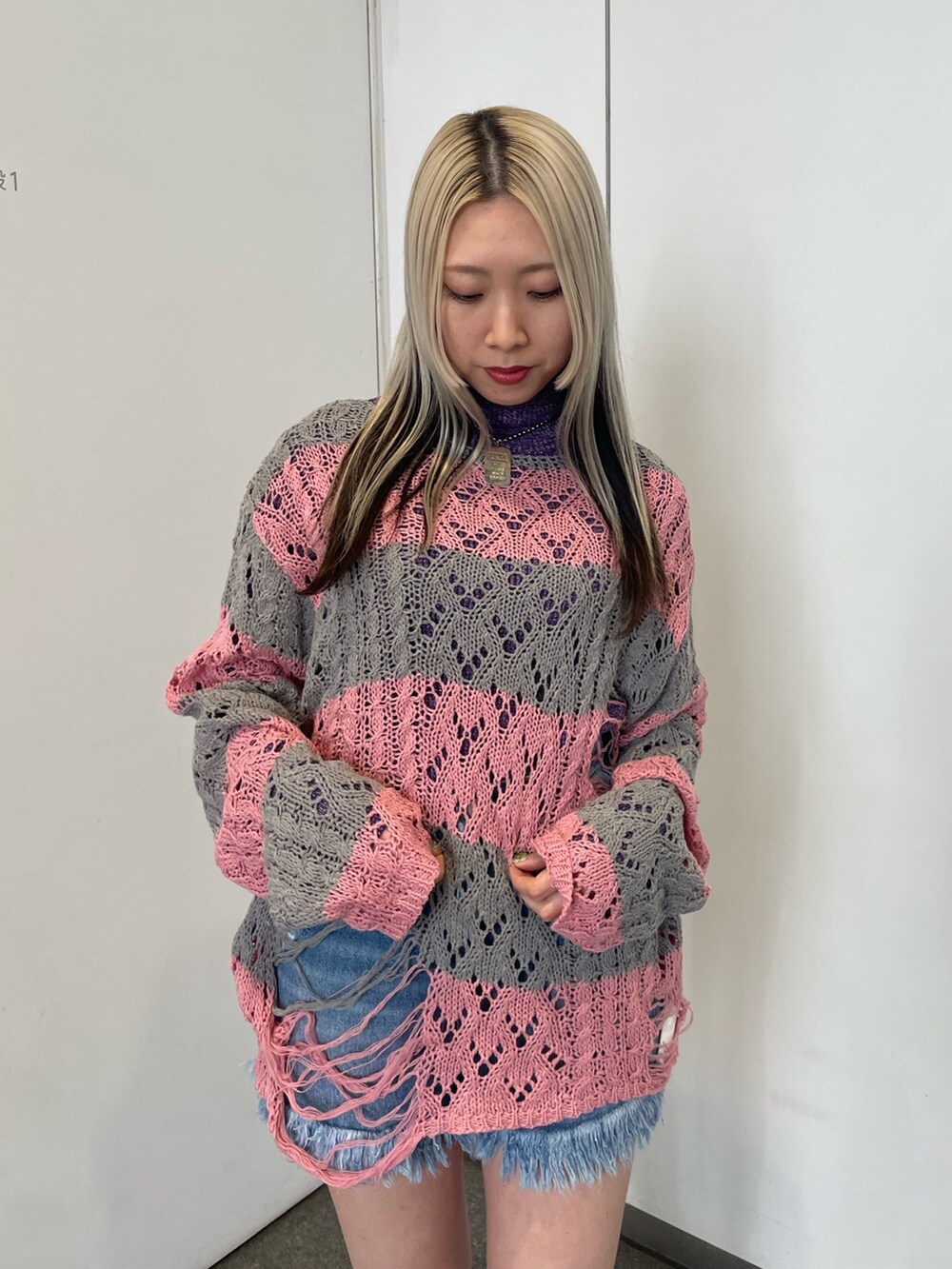 ピンク系のニット/セーター、パープル系のニット/セーター、ブルー系のデニムパンツを着用したレディースの冬コーディネートの5枚目の写真