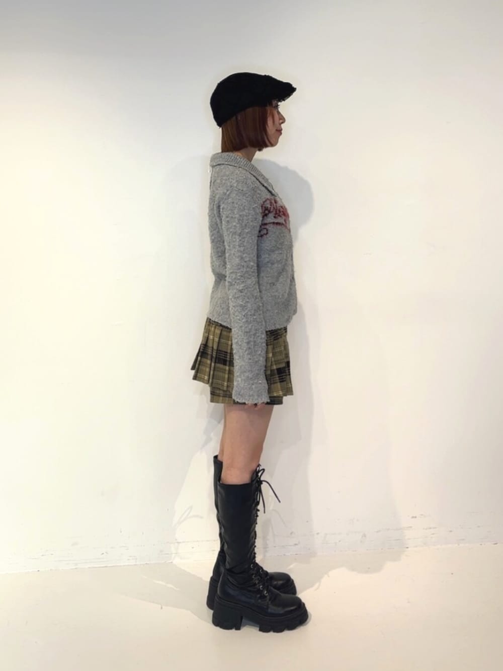 ブラック系のブーツ、ブラウン系のその他パンツ、グレー系のカーディガン/ボレロを着用したレディースの秋コーディネートの3枚目の写真