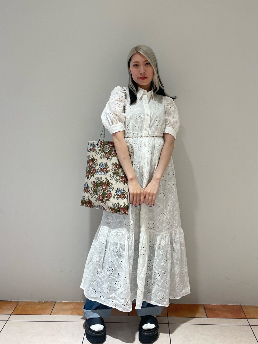 ホワイト系のワンピース、ブルー系のカーゴパンツ、その他のハンドバッグを着用したレディースの夏コーディネートの2枚目の写真