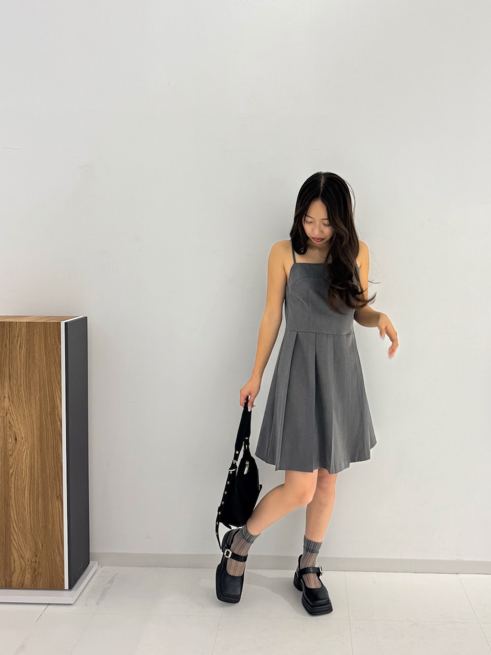 グレー系のワンピース、ブラック系のローファー、ブラック系のトートバッグを着用したレディースの春コーディネートの5枚目の写真