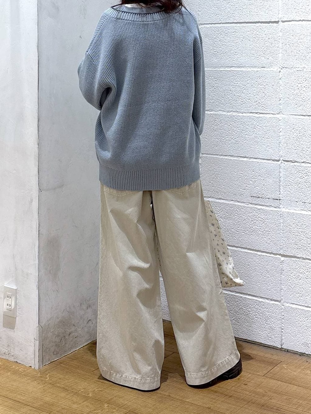 その他のトートバッグ、ブルー系のカーディガン/ボレロ、ホワイト系のデニムパンツを着用したレディースの冬コーディネートの3枚目の写真