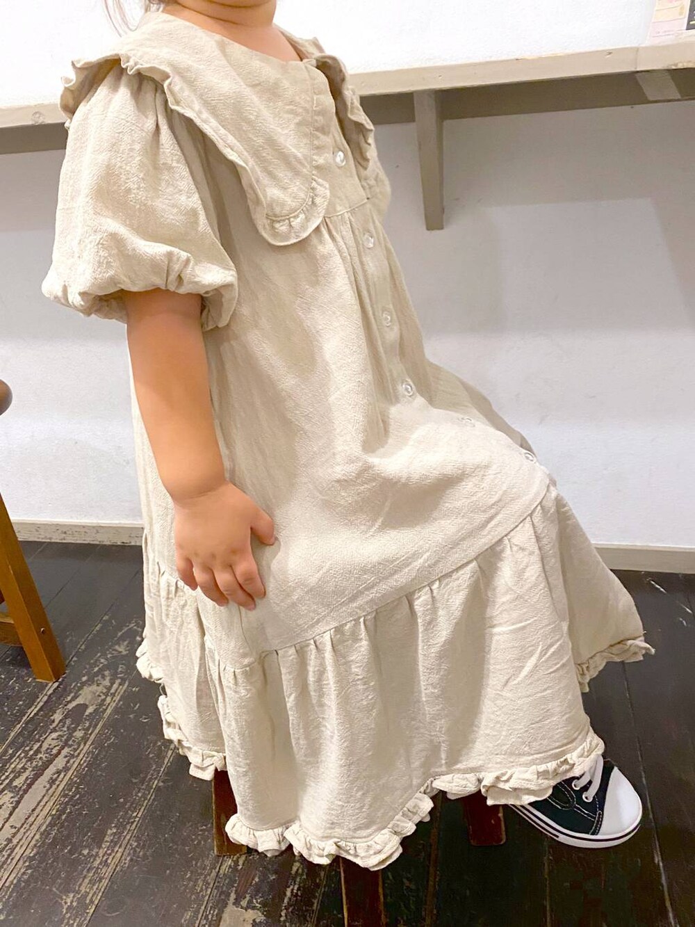 ベージュ系のワンピースを着用したキッズの夏コーディネートの2枚目の写真