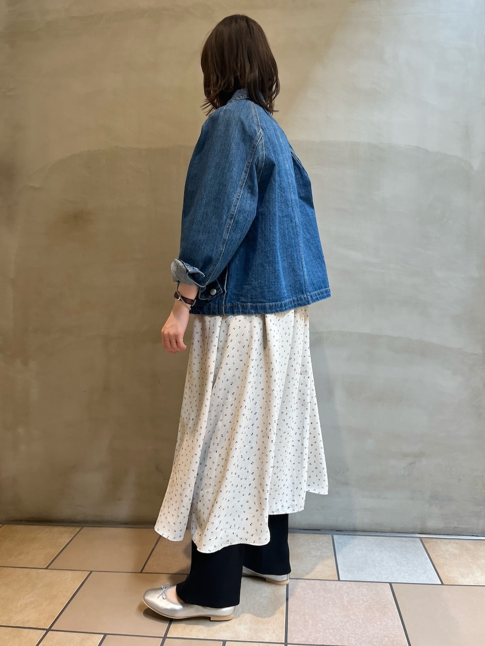 ブルー系のカバーオール、シルバー系のバレエシューズ、ブラック系のその他パンツを着用したレディースの春コーディネートの2枚目の写真