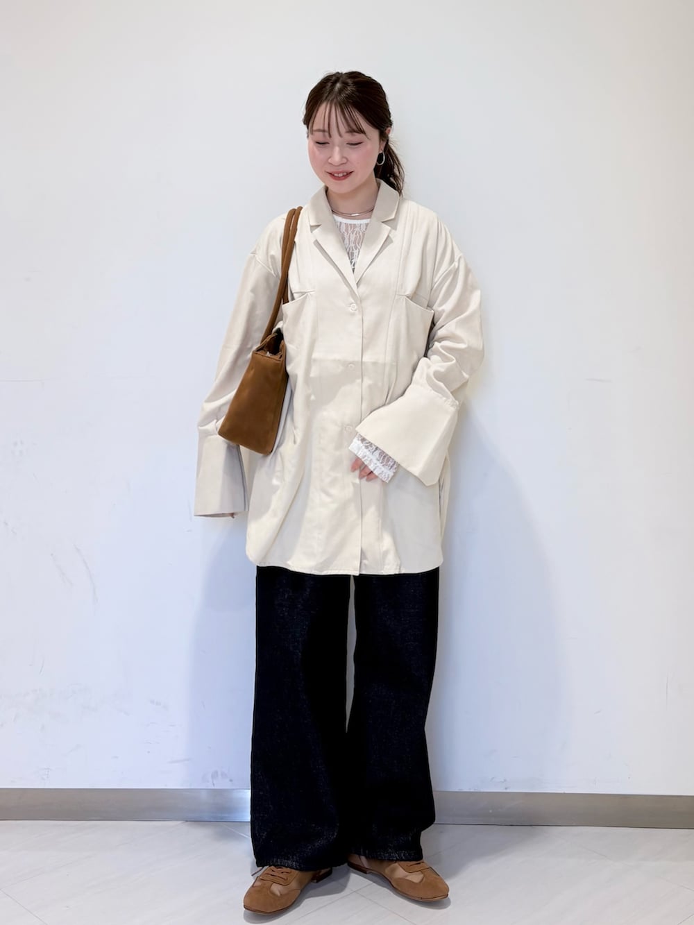 ホワイト系のシャツ/ブラウス、ブルー系のデニムパンツ、イエロー系のボストンバッグを着用したレディースの冬コーディネートの4枚目の写真