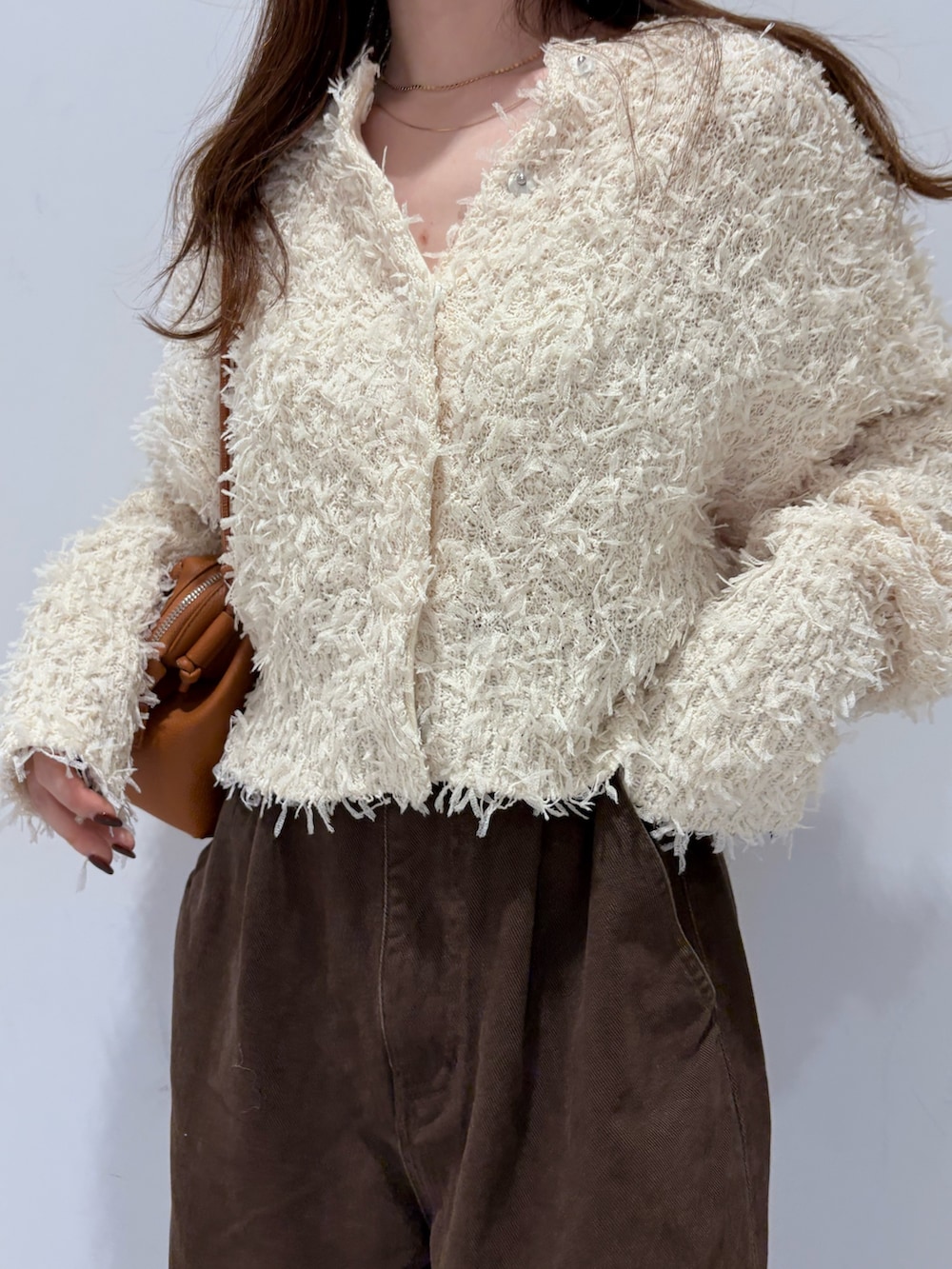 ホワイト系のニット/セーター、イエロー系のショルダーバッグ、ブラウン系のその他パンツを着用したレディースの秋コーディネートの3枚目の写真