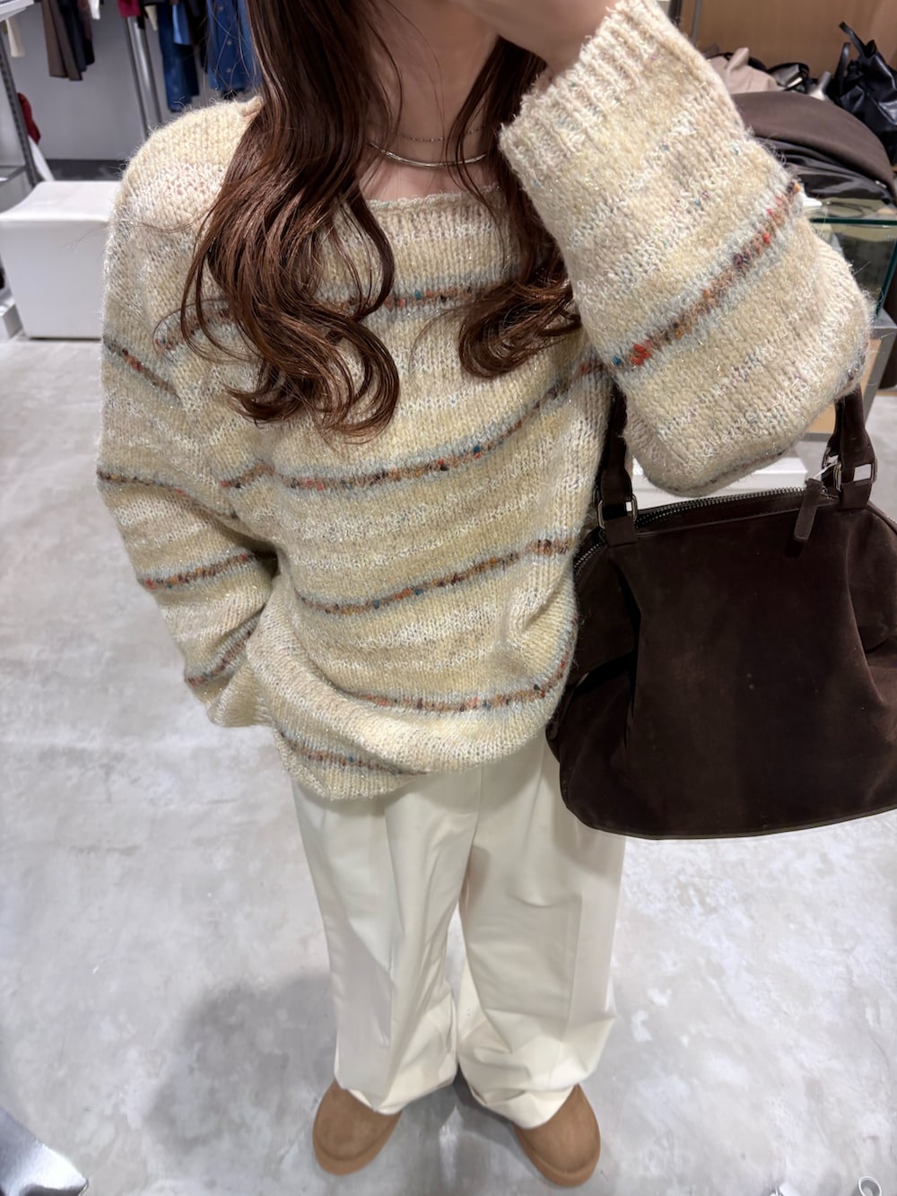 ブラウン系のその他アウター、ホワイト系のニット/セーター、ブラウン系のボストンバッグを着用したレディースの冬コーディネートの7枚目の写真