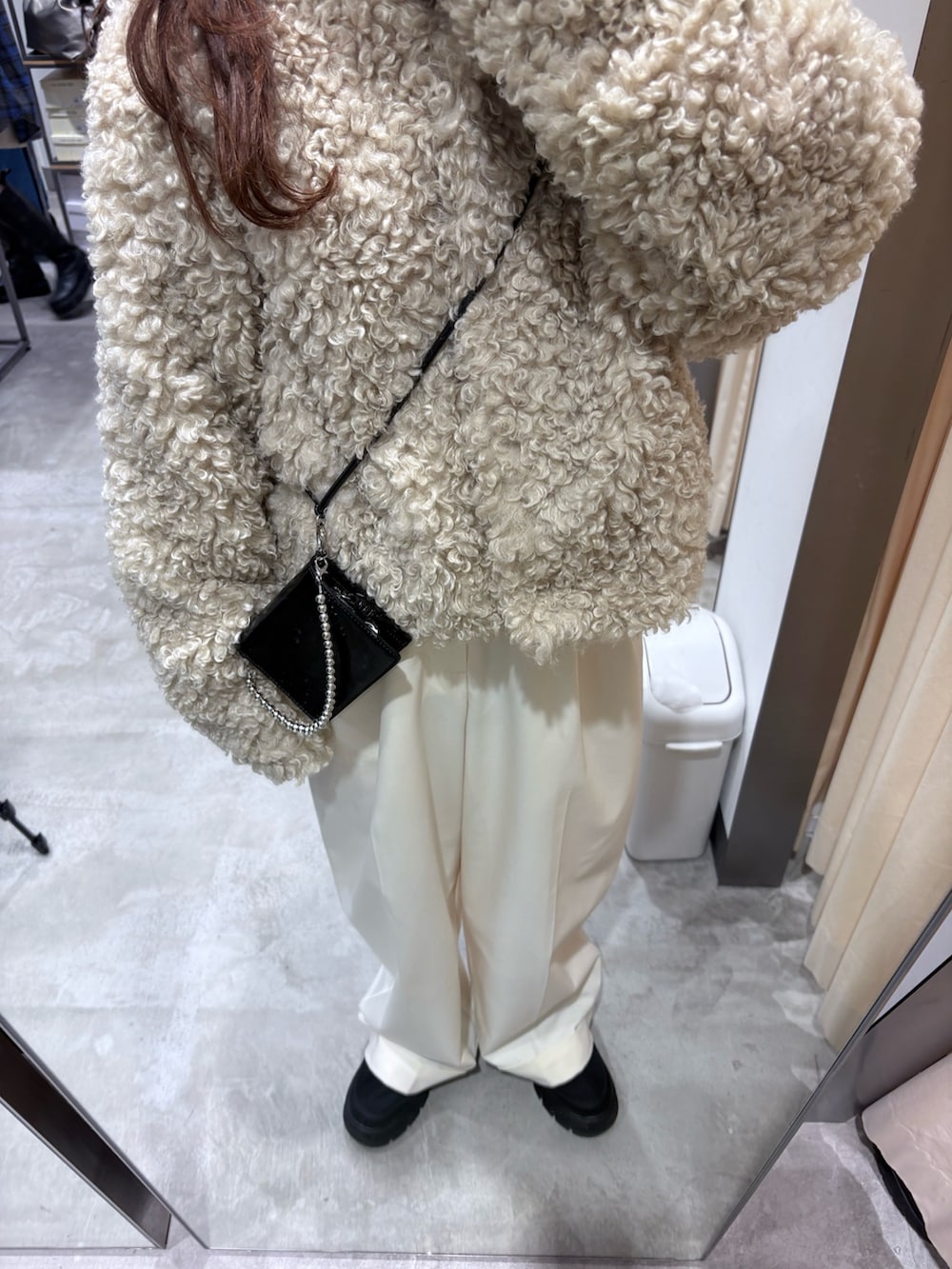 ホワイト系のその他アウター、ホワイト系のその他パンツ、ブラック系のスニーカーを着用したレディースの冬コーディネートの3枚目の写真