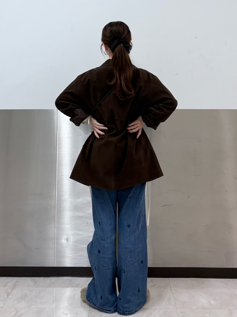 ブラウン系のその他アウター、ホワイト系のシャツ/ブラウス、ブルー系のデニムパンツを着用したレディースの秋コーディネートの3枚目の写真