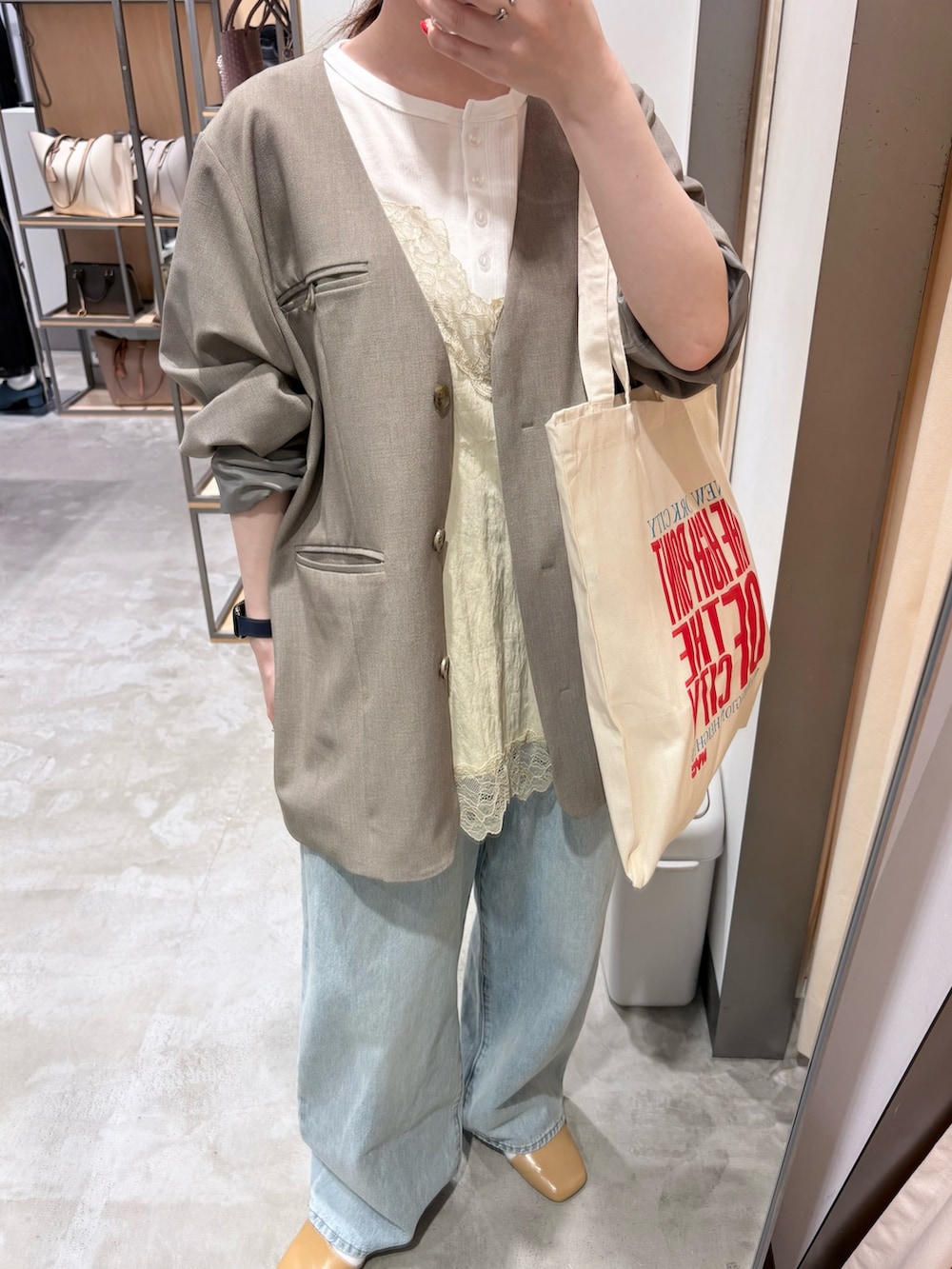 ホワイト系のTシャツ/カットソー、グレー系のノーカラージャケット、ブルー系のデニムパンツを着用したレディースの春コーディネートの4枚目の写真