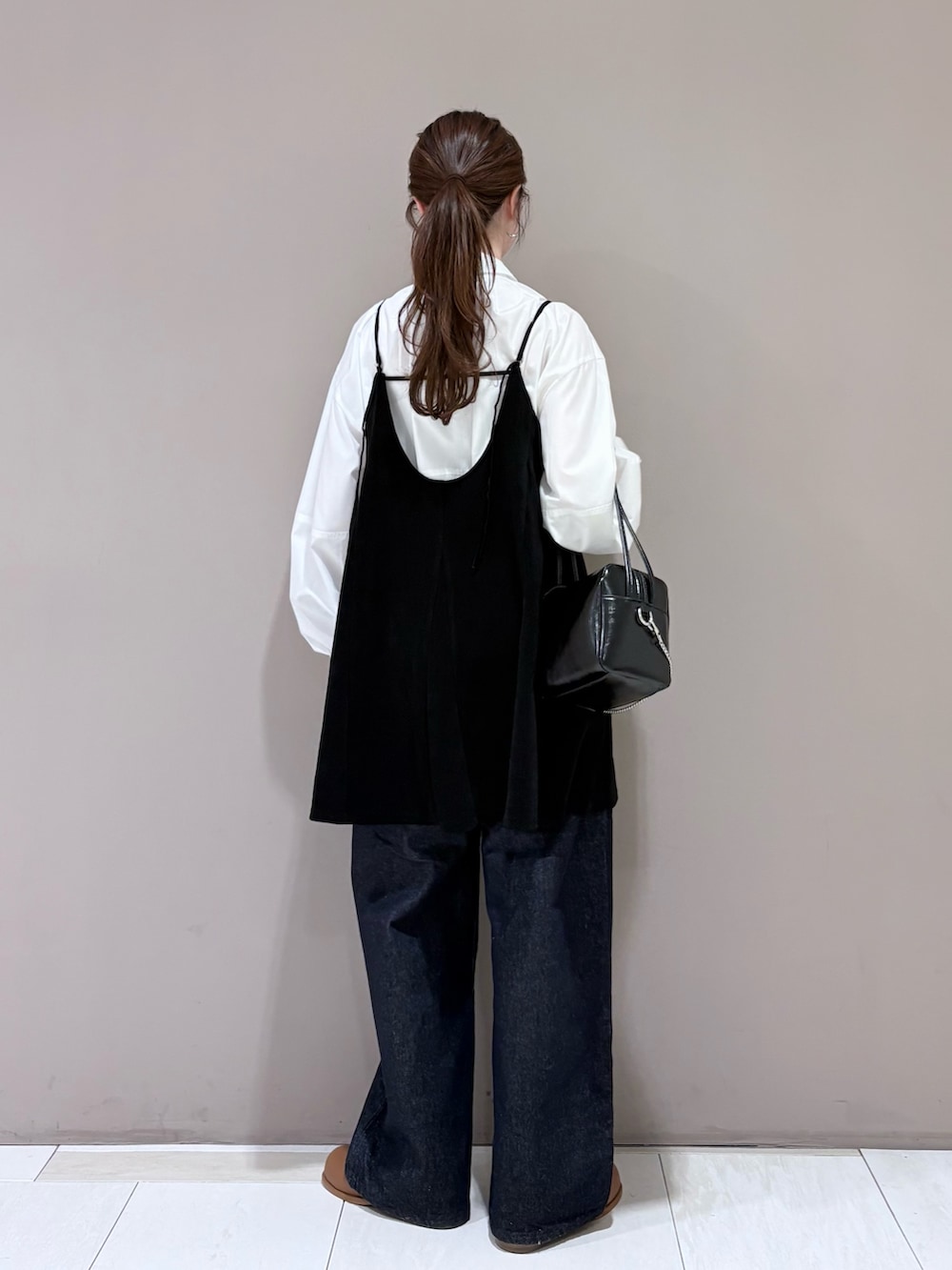 ホワイト系のシャツ/ブラウス、ブラック系のワンピース、ブラウン系のブーツを着用したレディースの冬コーディネートの2枚目の写真