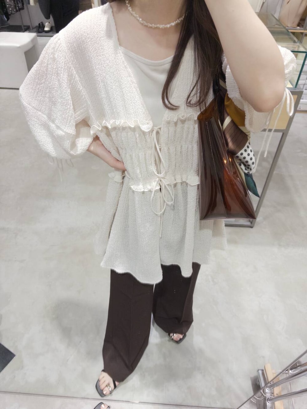 ブラウン系のトートバッグ、ブラウン系のサンダル、ブラウン系のその他パンツを着用したレディースの夏コーディネートの3枚目の写真