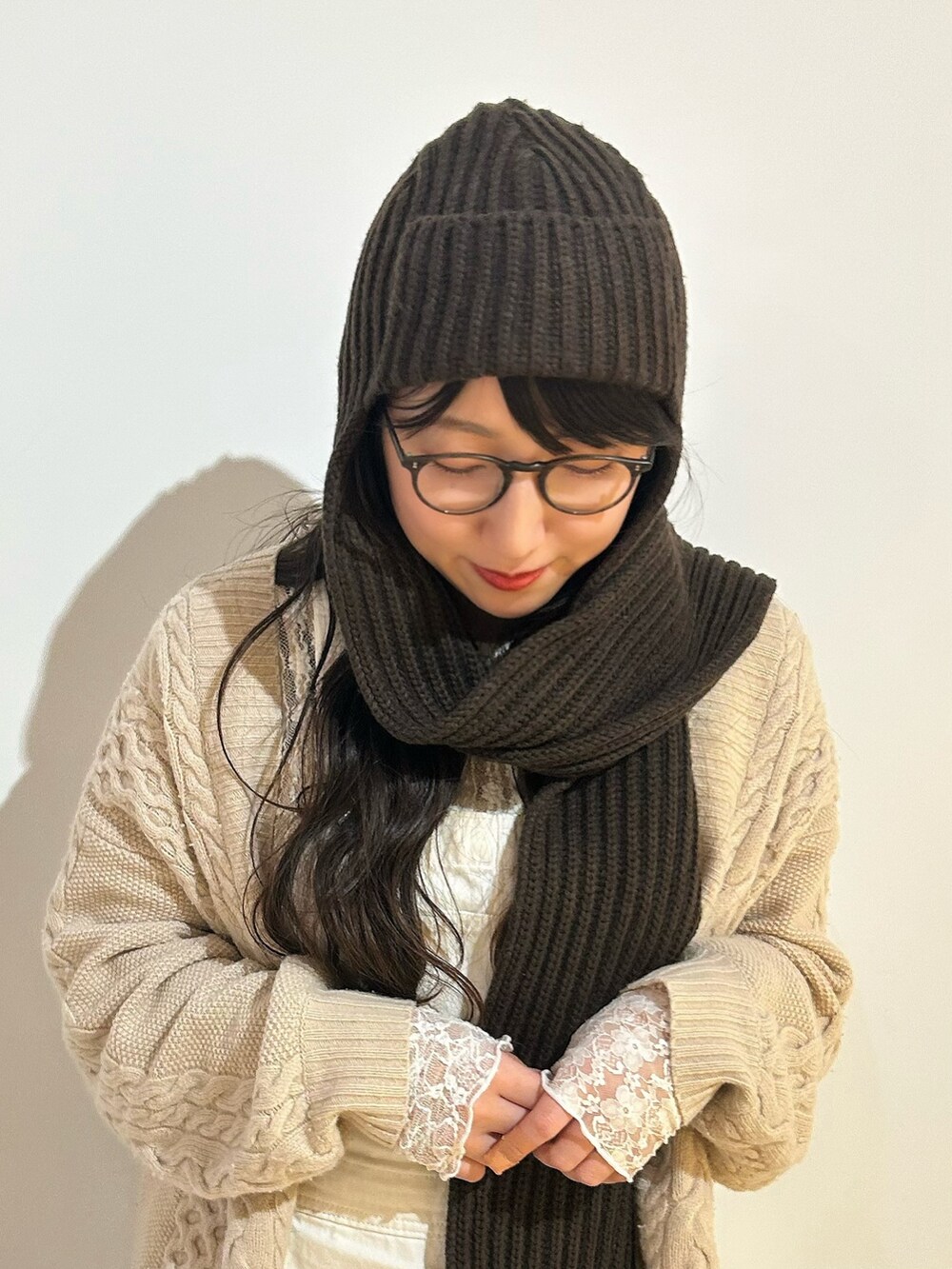 ホワイト系のカーディガン/ボレロ、ホワイト系のオールインワン・サロペット、レッド系のブーツを着用したレディースの秋コーディネートの2枚目の写真