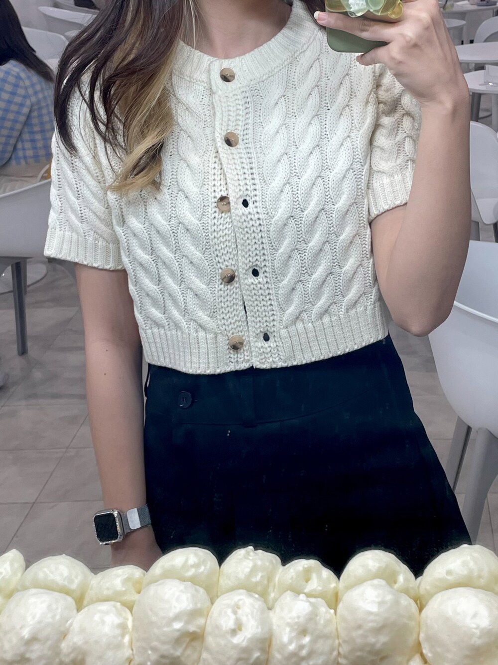 ブラック系のスカート、ホワイト系のニット/セーターを着用したレディースの春コーディネートの3枚目の写真