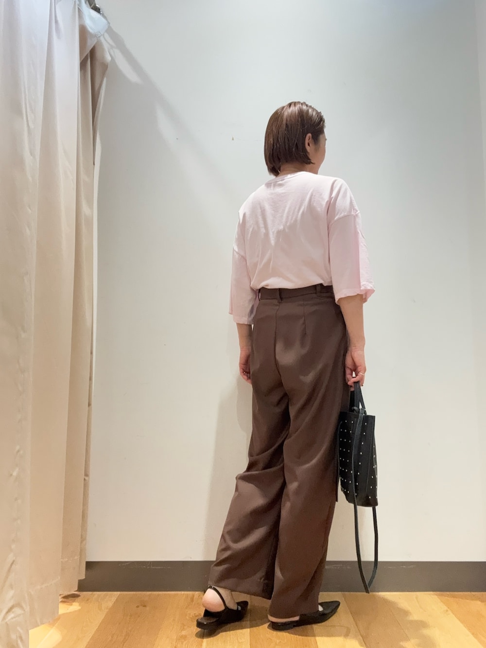 ブラウン系のその他パンツ、ピンク系のTシャツ/カットソー、ブラック系のトートバッグを着用したレディースの春コーディネートの2枚目の写真