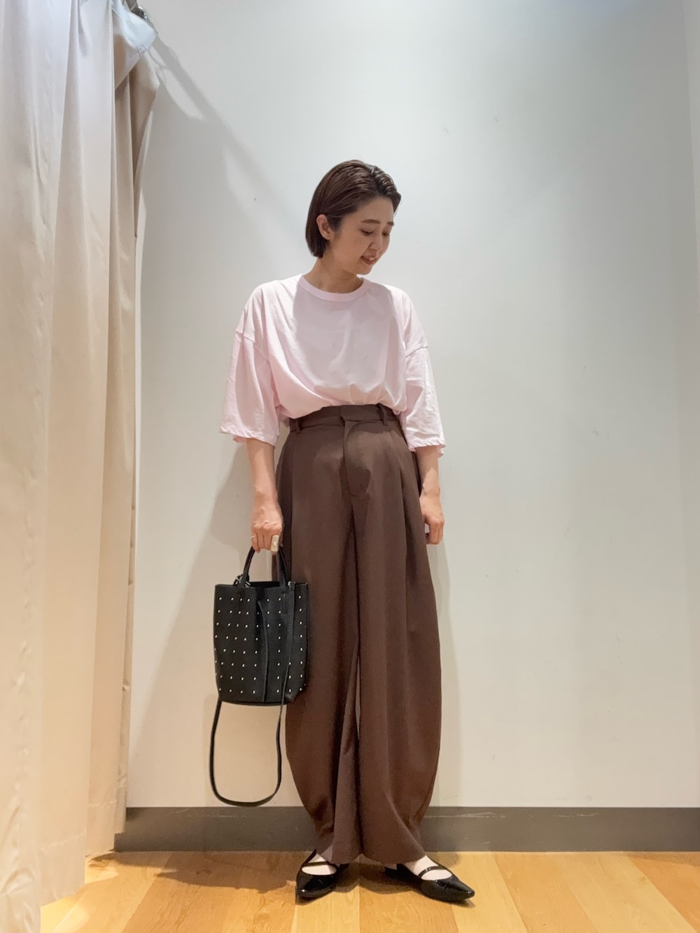 ブラウン系のその他パンツ、ピンク系のTシャツ/カットソー、ブラック系のトートバッグを着用したレディースの春コーディネートの3枚目の写真
