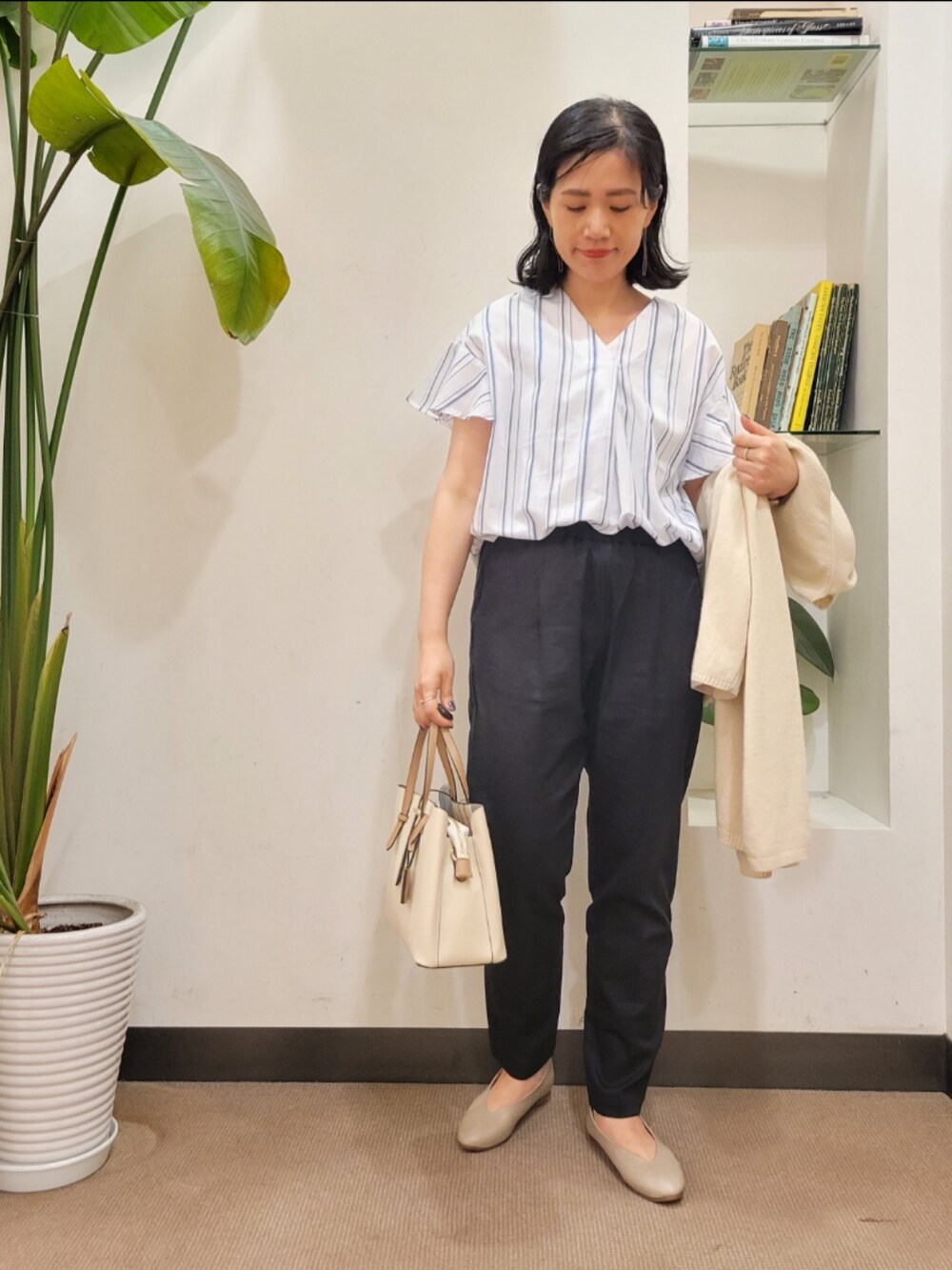ベージュ系のパンプス、ホワイト系のカーディガン/ボレロ、ホワイト系のトートバッグを着用したレディースの春コーディネートの4枚目の写真