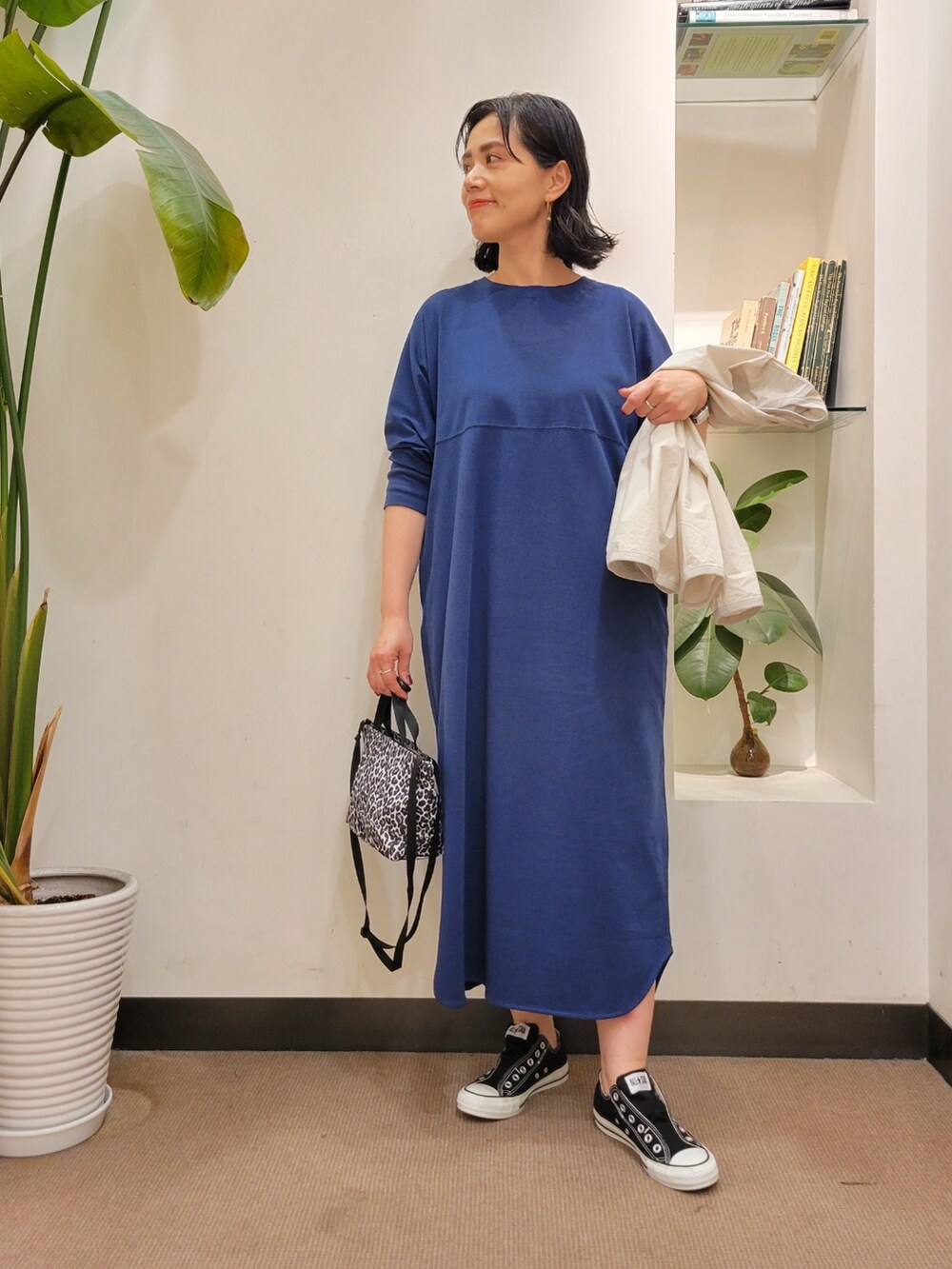 ホワイト系のショルダーバッグ、グレー系のノーカラージャケット、ブルー系のワンピースを着用したレディースの春コーディネートの4枚目の写真