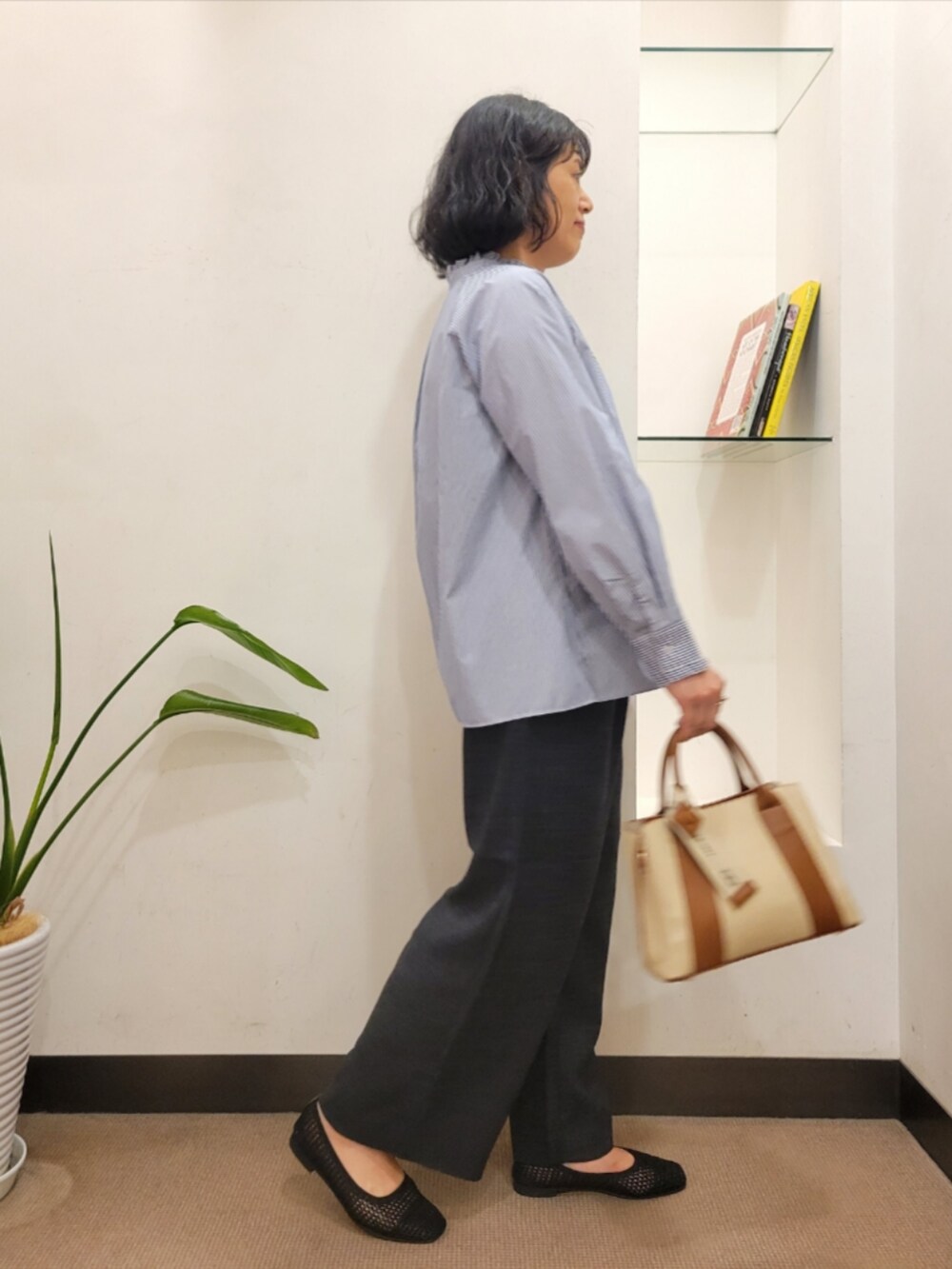 グレー系のその他パンツ、ブラック系のバレエシューズ、ホワイト系のハンドバッグを着用したレディースの夏コーディネートの3枚目の写真