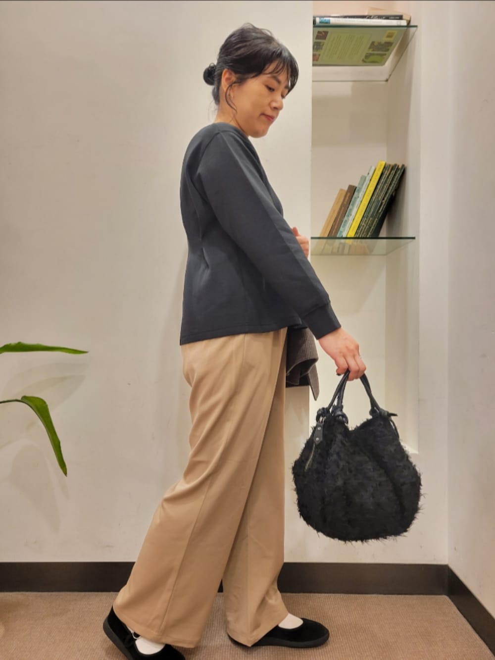 ブラック系のハンドバッグ、その他のその他アウター、ベージュ系のその他パンツを着用したレディースの秋コーディネートの5枚目の写真