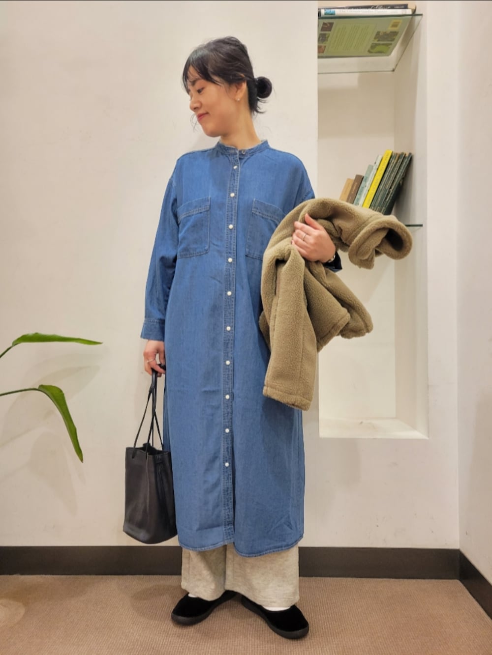 ブラック系のショルダーバッグ、ベージュ系のブルゾン、ブルー系のワンピースを着用したレディースの秋コーディネートの4枚目の写真