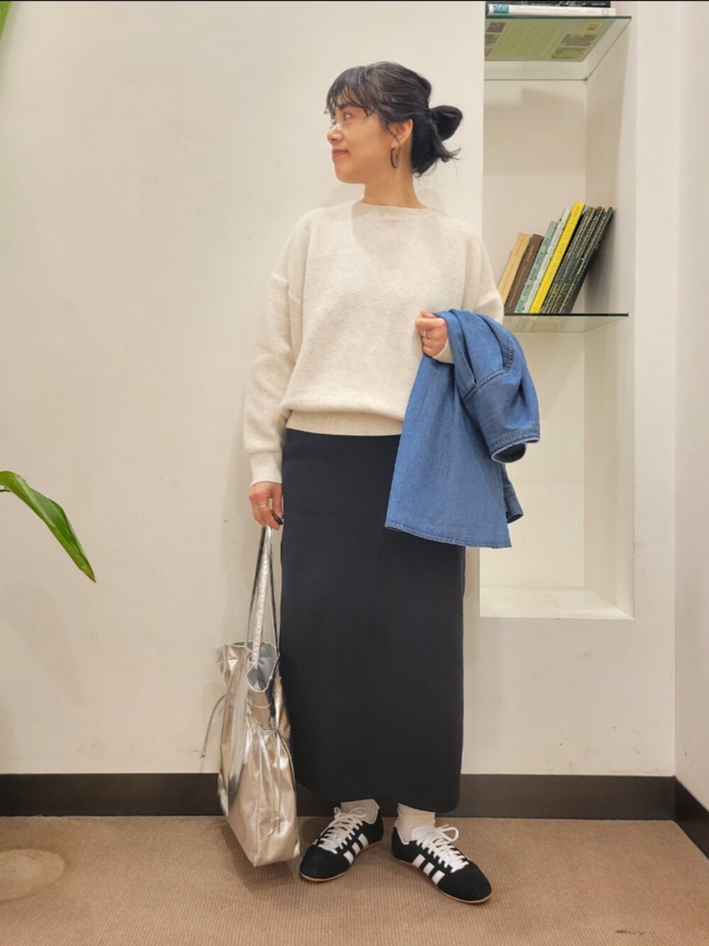 シルバー系のトートバッグ、ブルー系のシャツ/ブラウス、ブラック系のスカートを着用したレディースの冬コーディネートの4枚目の写真