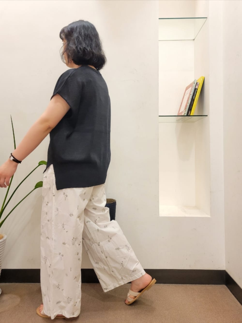 ブルー系のトートバッグ、ブラック系のその他トップス、ホワイト系のサンダルを着用したレディースの夏コーディネートの5枚目の写真