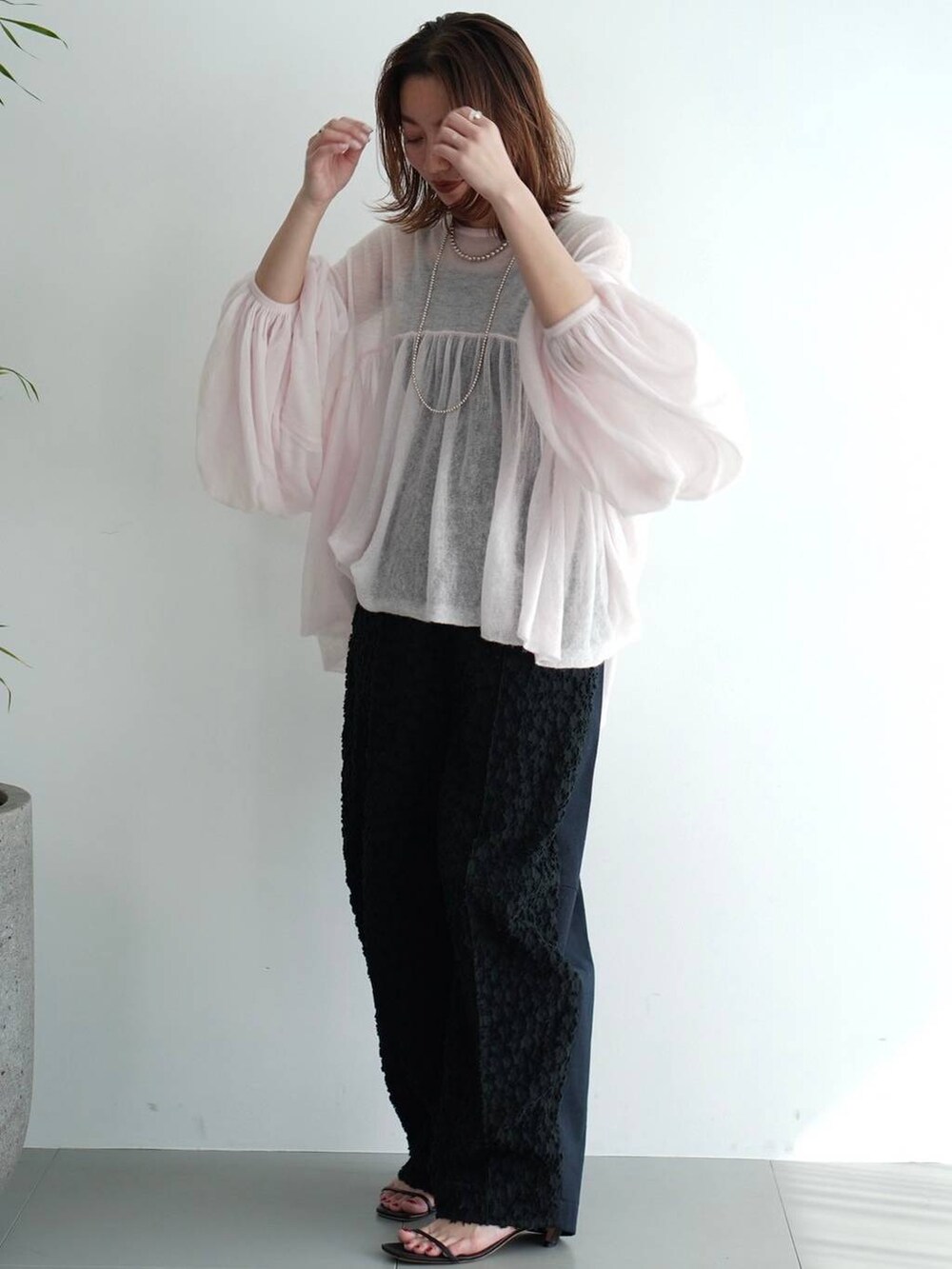 ブラック系のその他パンツ、ピンク系のニット/セーターを着用したレディースの夏コーディネートの2枚目の写真