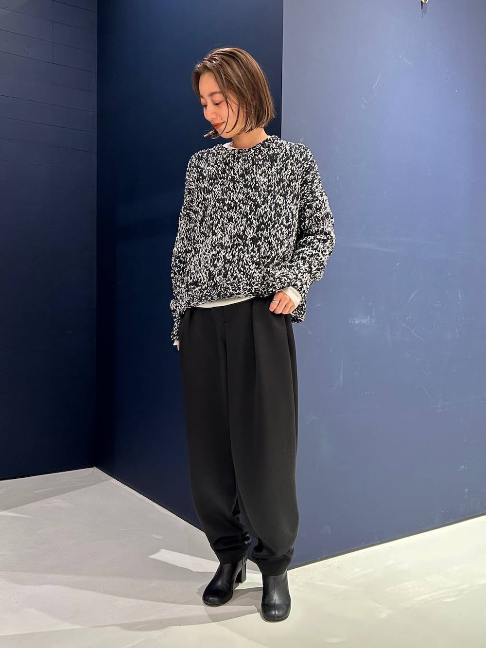 ブラック系のその他パンツ、ホワイト系のニット/セーター、ブラック系のニット/セーターを着用したレディースの冬コーディネートの2枚目の写真