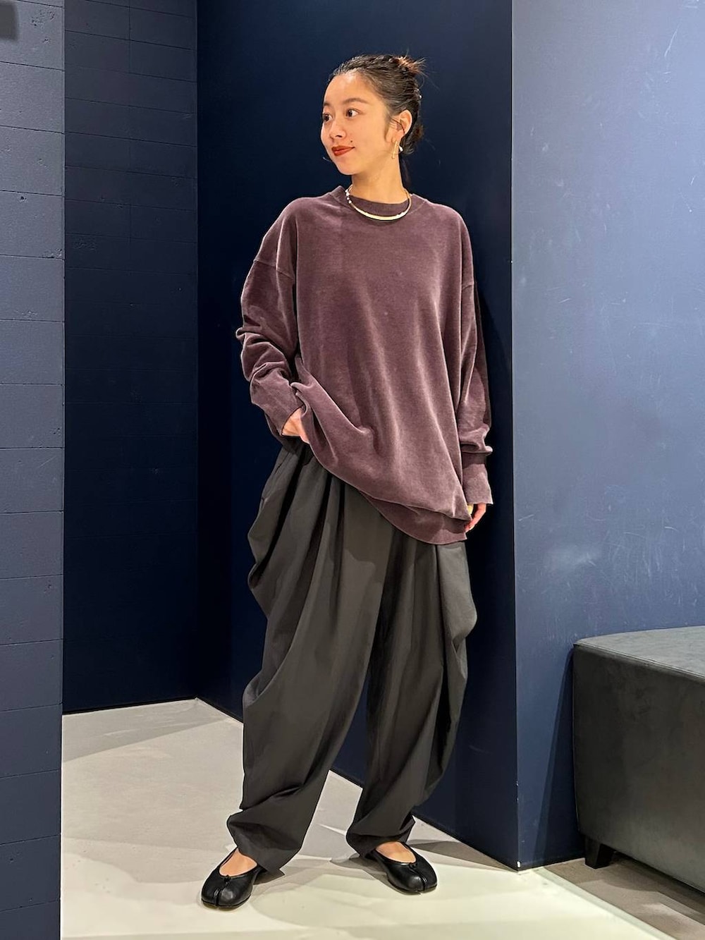 グレー系のその他パンツ、グレー系のニット/セーター、ゴールド系のチョーカーを着用したレディースの夏コーディネートの2枚目の写真